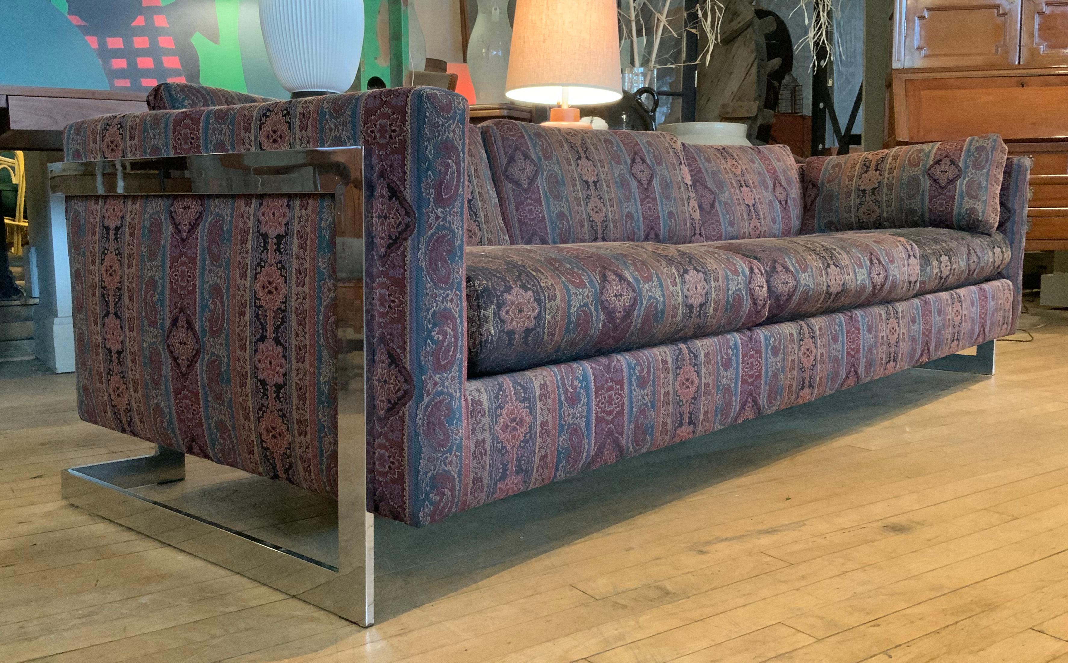 a beautiful 1960's three seat sofa by Milo Baughman, with a stunning chrome frame the holds the sofa 'floating' in the frame -- great design and very well made and in perfect condition. the sofa was reupholstered in the 1990's, and the fabric is in