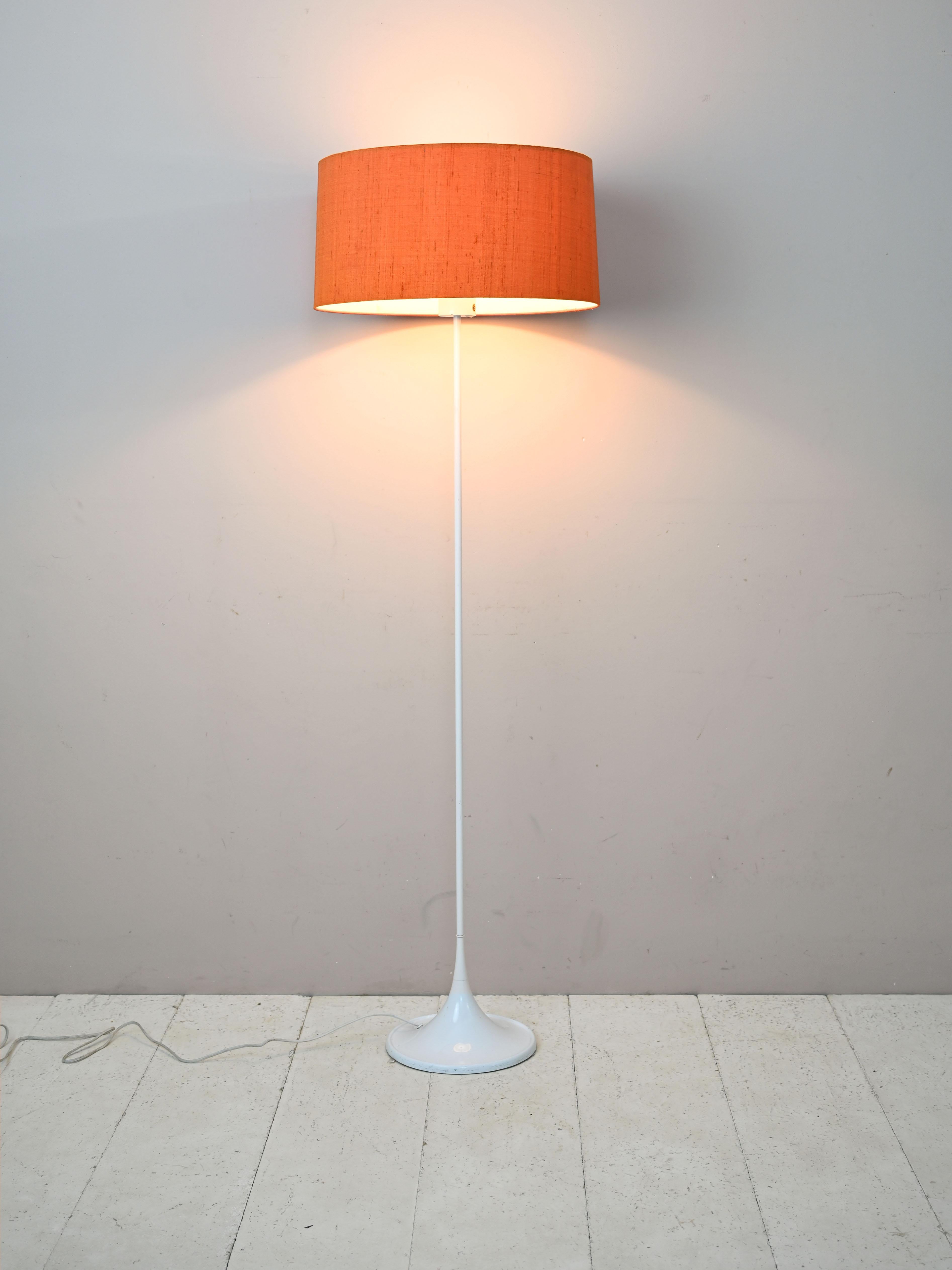 Scandinavian modernist vintage lamp made of plastic and fabric.

Consists of the white plastic frame and orange fabric shade.
Distinguished by the long, slender stem and the wide, colored lampshade that echoes midcentury taste and style.

Good
