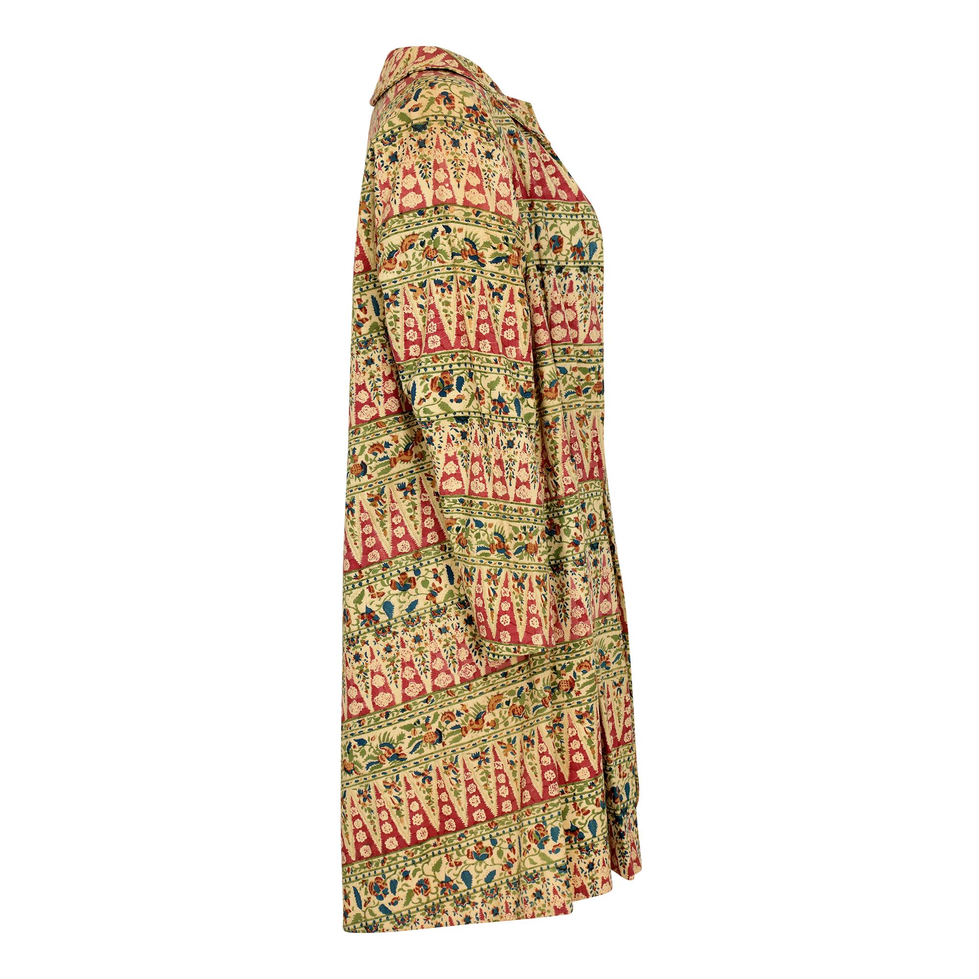 This is a really unusual jacket of its time - an early ethnic style block print. We have only ever seen these duster coats as a solid colour and in a more formal style as part of dress suit. This design is very open and features a high button Peter