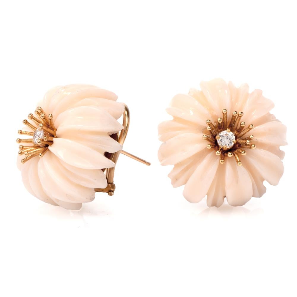 These 1950’S earrings are  crafted in 14 karat yellow gold, weighing 22.4 grams and measuring  22 mm wide. They incorporate a pair of flower heads meticulously carved in genuine off-white coral. The earrings are centered with 2 round-faceted