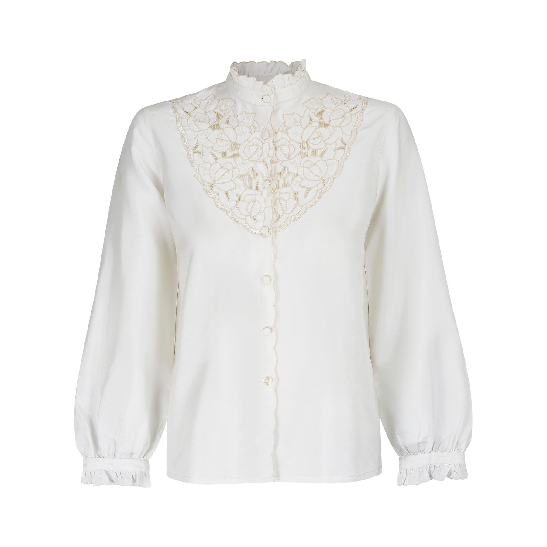 We really love these types of blouses and although this one is unlabelled, it was most likely made in the Far East in the 1960s or 1970s. It feels like a silky man-made blend. The entire bib area of the neck is embroidered and has cut out elements