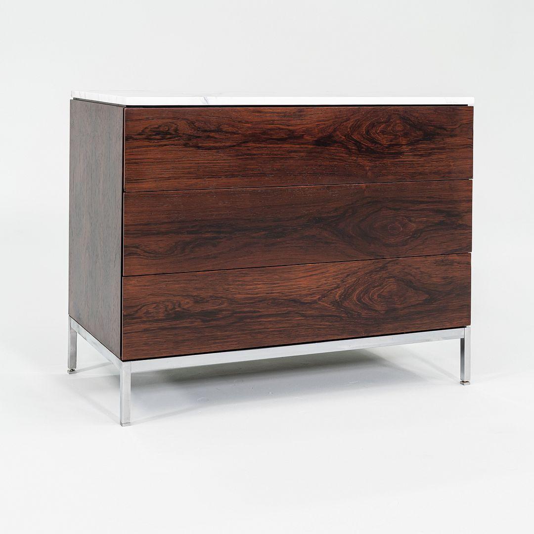 This is a Three-Drawer Dresser, designed by Florence Knoll for Knoll International in 1958. This example dates to the 1960s and features a rich Brazilian rosewood veneer. The wooden case sports three wide drawers and sits atop a chromed-steel base