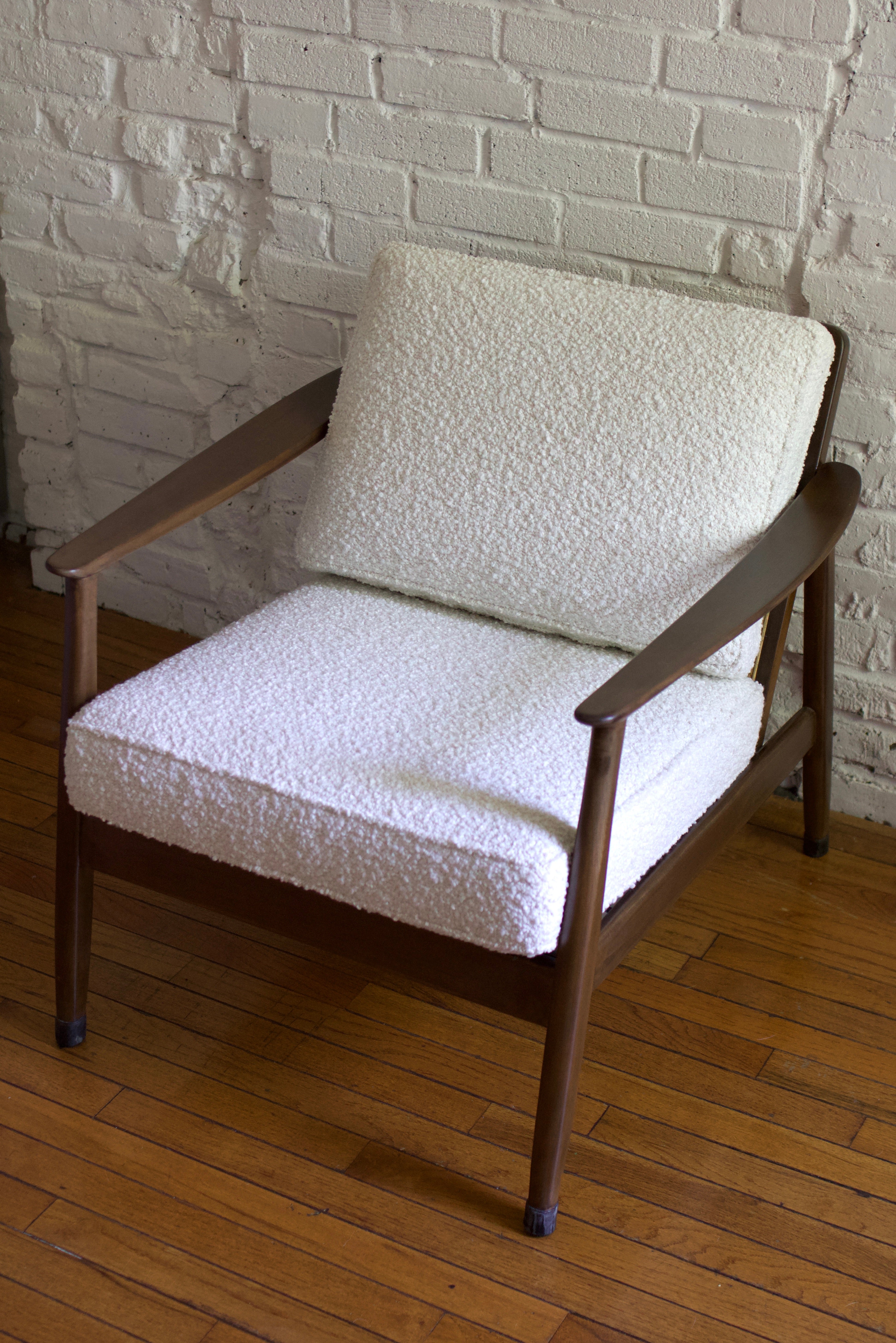 1960s Swedish armchair designed by Folke Ohlsson for Dux in teak wood and Rattan. Sweden, 1960s. Excellently restored and reupholstered in a creamy white boucle. Espresso-finished teak frame and rattan in fantastic condition.

With a timeless,