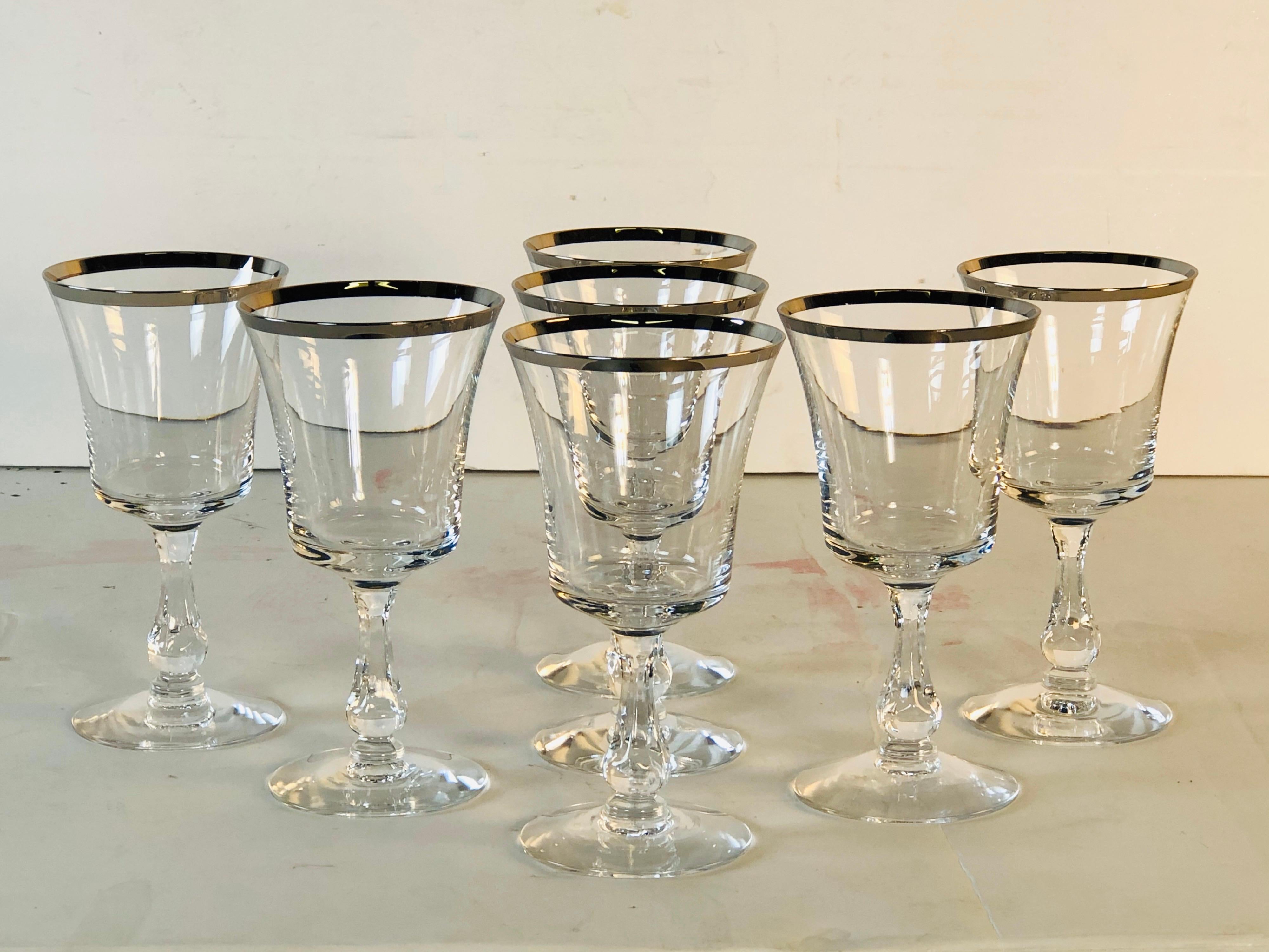 Vintage 1960s set of 9 Fostoria Glass platinum rim small wine stems. Excellent condition. Marked underneath.
       