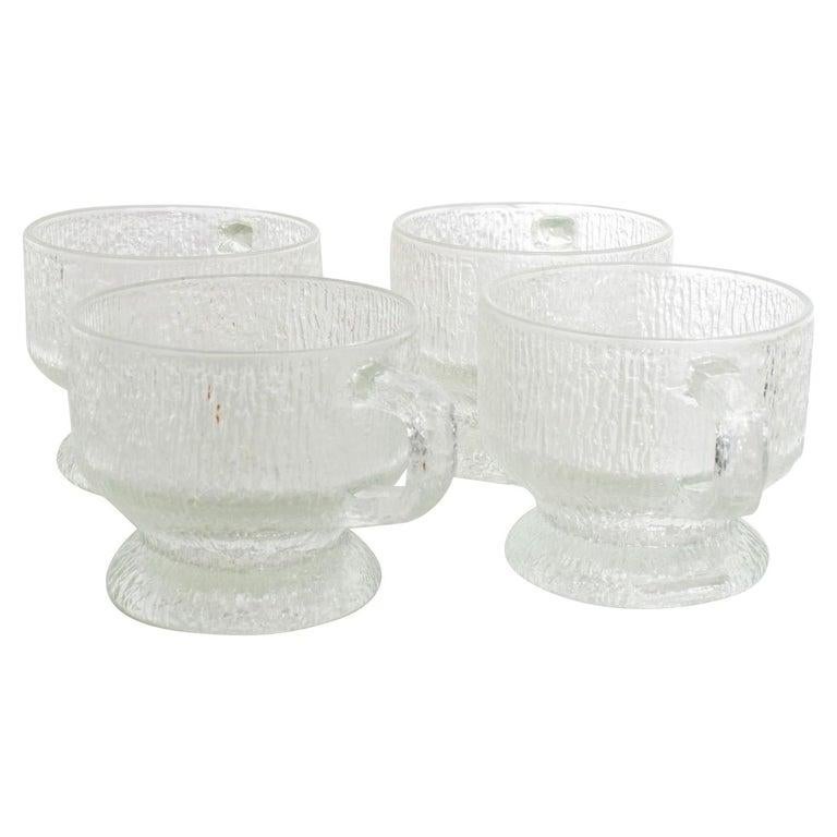 Vintage Scandinavian Frosted Ice Glass Mugs Set of Four
Frosted glass style of Tapio Wirkkala for IITTALA. Ultima Thule, Finland.
No label 3.38 H x 5 D x 4 in diameter
Original preowned vintage condition. 
Please review all images.