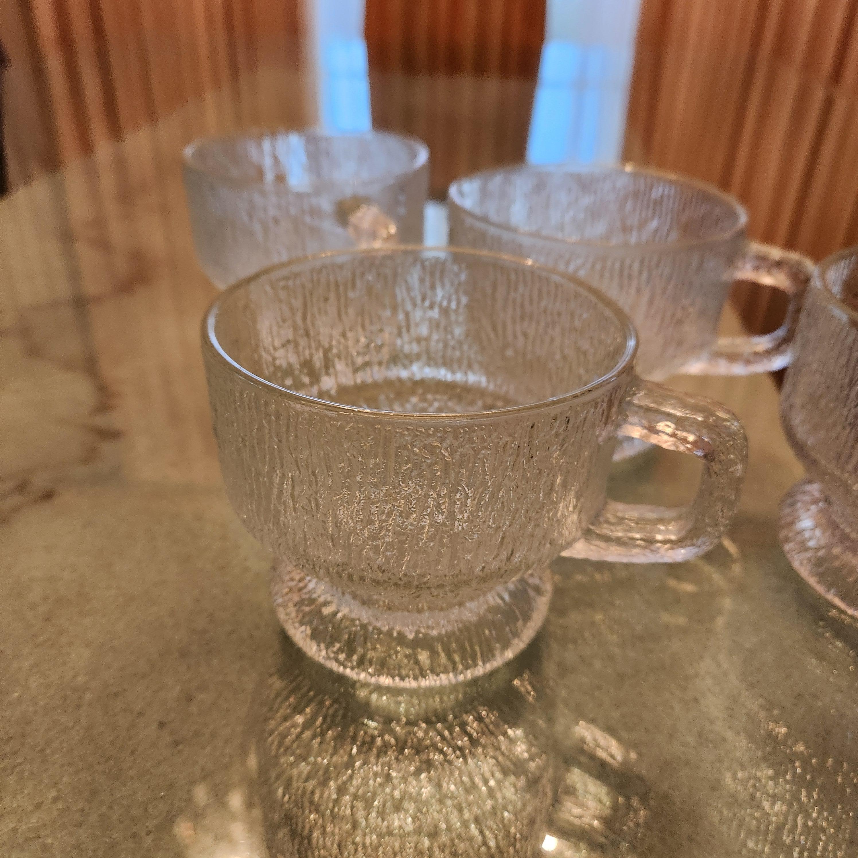 Vintage Scandinavian Frosted Ice Glass Mugs Set of Four
Frosted glass style of Tapio Wirkkala for IITTALA. Ultima Thule, Finland.
No label 3.38 H x 5 D x 4 in diameter
Original preowned vintage condition. 
Please review all images.