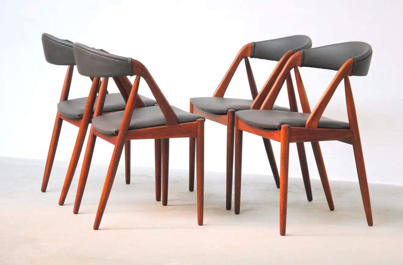 Kai Kristiansen set of four fully restored teak dining chairs by Schou Andersens Møbel Fabrik including custom upholstery.

The A-frame model 31 dining chairs were designed by Kai Kristiansen in 1956 for Schou-Andersens Møbelfabrik and the A-frame