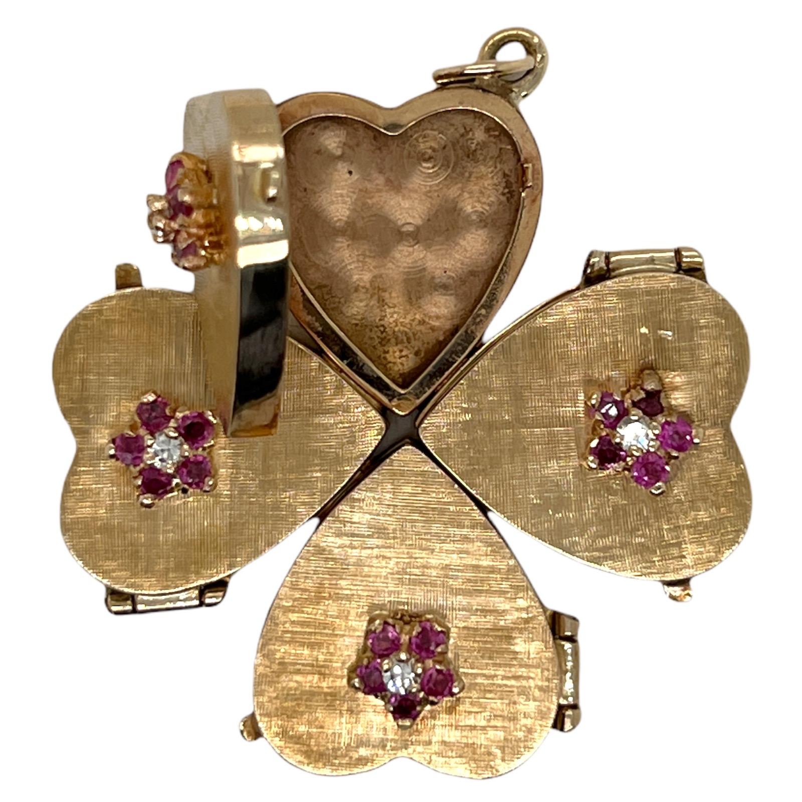 Vintage four leaf clover locket fashioned in textured 14 karat yellow gold. The locket is adorned with 4 single cut diamonds (.12 CTW) and 20 round cut rubies. Each of the four leaves opens into a separate locket. Measuring 1.5 x 1.5 inches, the