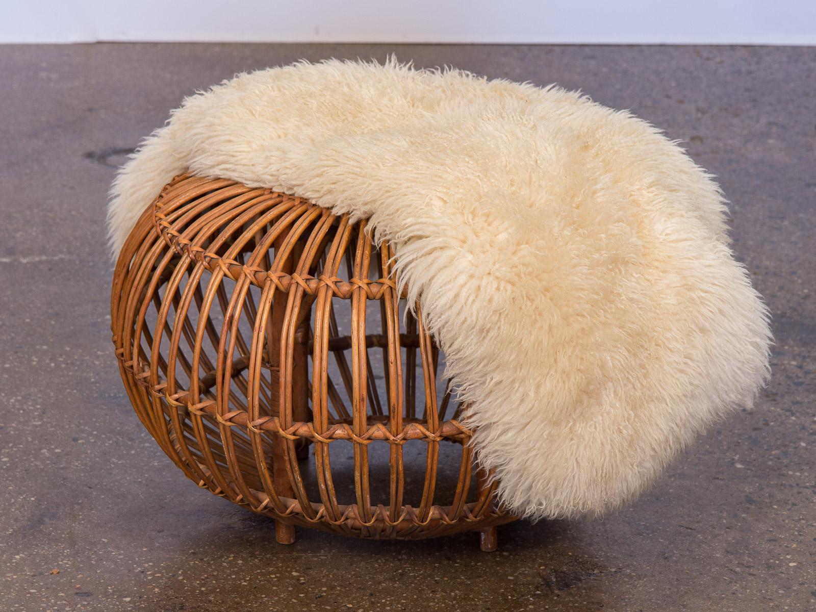 Vintage woven rattan ottoman in the manner of Franco Albini, designed in 1951. Age-appropriate wear to the woven rattan, but ours is a very nice, clean example from the 1960s. Sound construction woven ties are tightly bound. A stylish, circular pouf