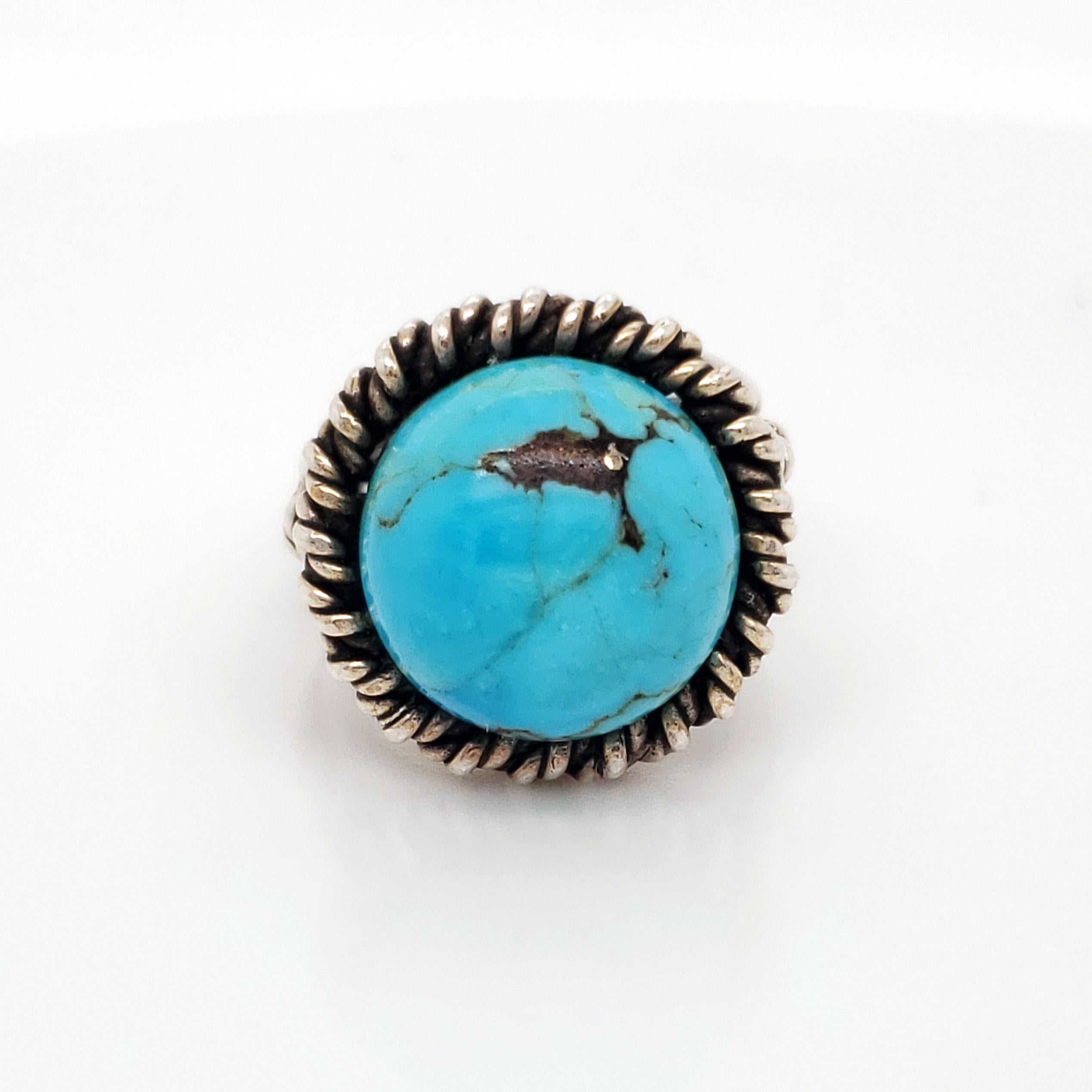 This turquoise ring is stunning! Big and bold, this ring was hand made by Fred Skagg, and it is stamped with his mark and signature on the under-gallery. Dated to the 1960s, this ring features a vibrant turquoise stone and gorgeous twisted silver
