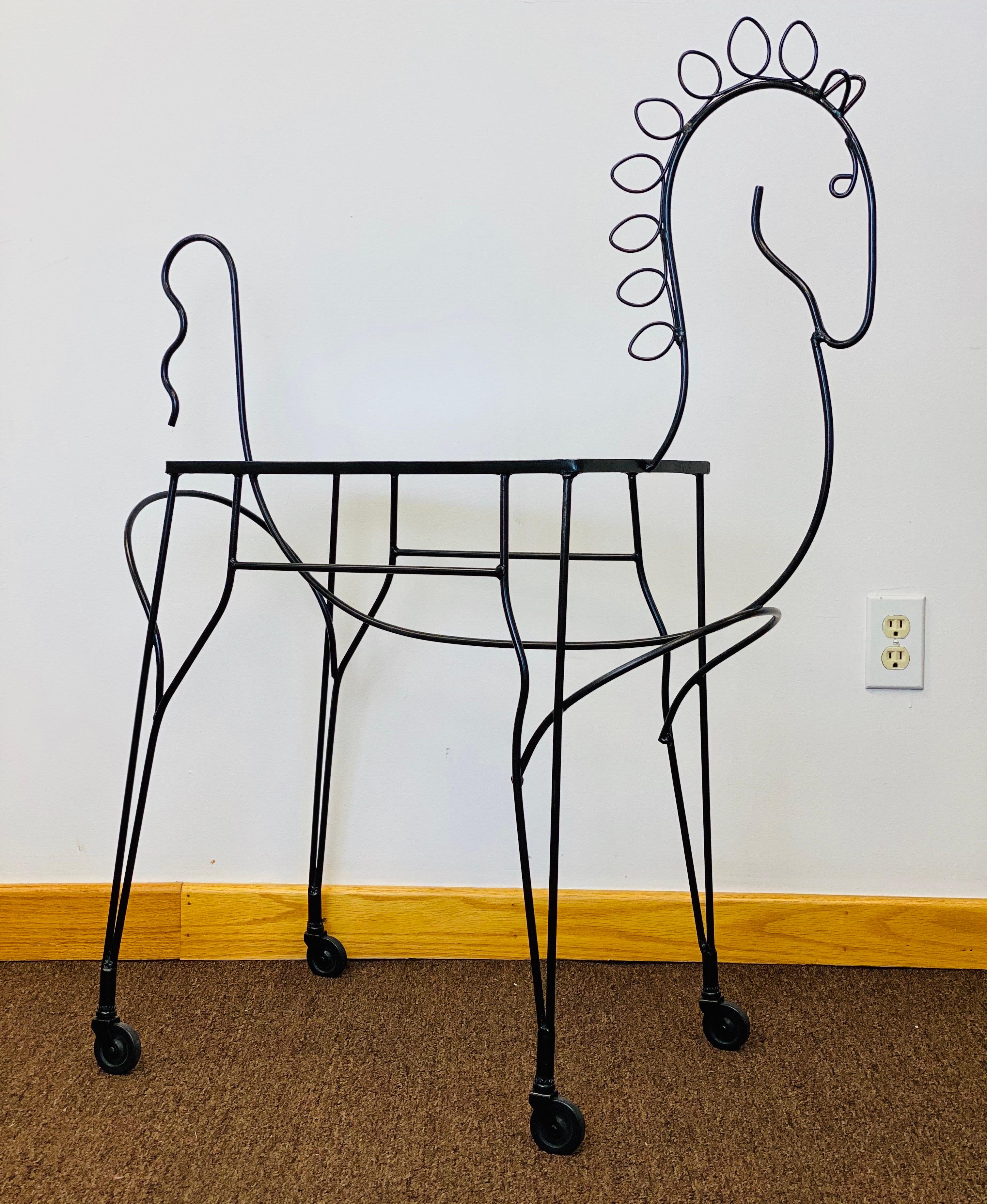We are very pleased to offer a playful bar cart, circa the 1960s.  This horse-shaped bar cart in the style of Frederick Weinberg, showcases an iron frame that embodies the mid-century modern aesthetic—clean lines, and geometric shapes.  The
