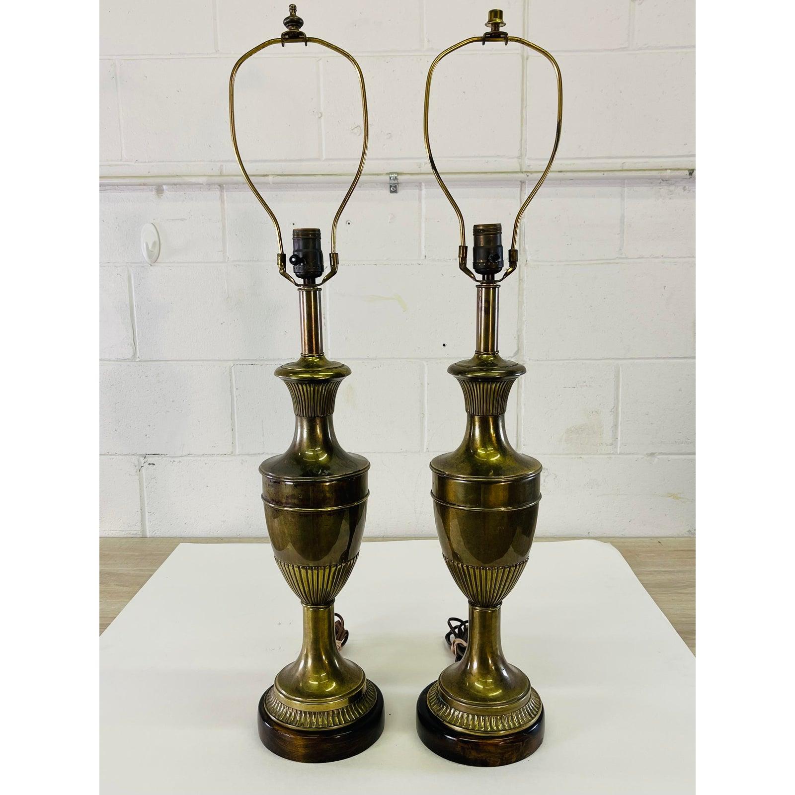 Vintage 1960s pair of brass and mahogany base table lamps designed by Frederick Cooper. The lamps are wired for the US and in working condition. Socket, 24.5” height Harp, 6” diameter x 9.5”H. Marked.