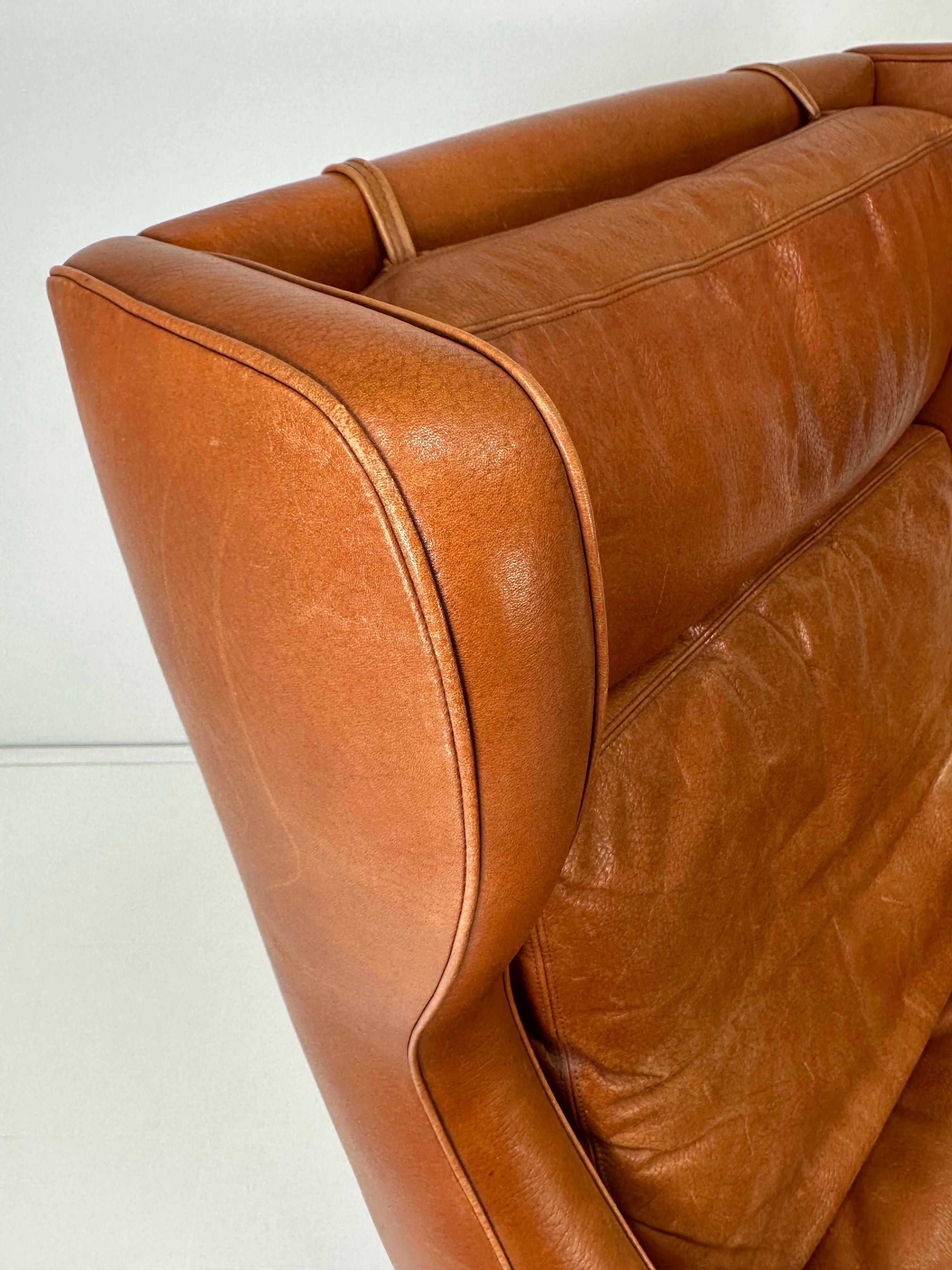 Frederik Kayser leather lounge chair for Vatne Mobler, Norway. 1960’s. Wingback chair with rosewood base and original cognac leather. Unmarked.