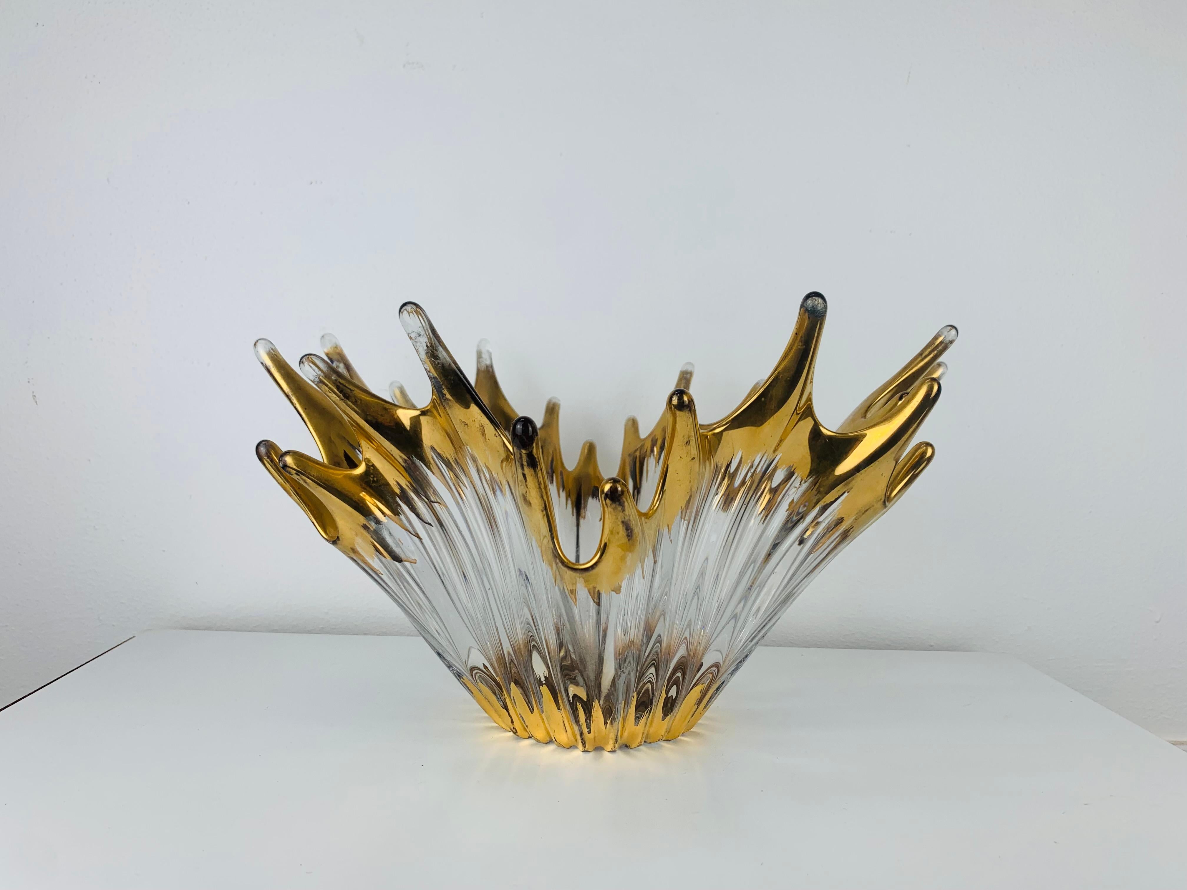 Free form golden glass bowl attributed to Cofrac Art Verrier France. The form reminds of a crown, with its long golden peaks. It is handmade/handblown in heavy clear art glass. 
