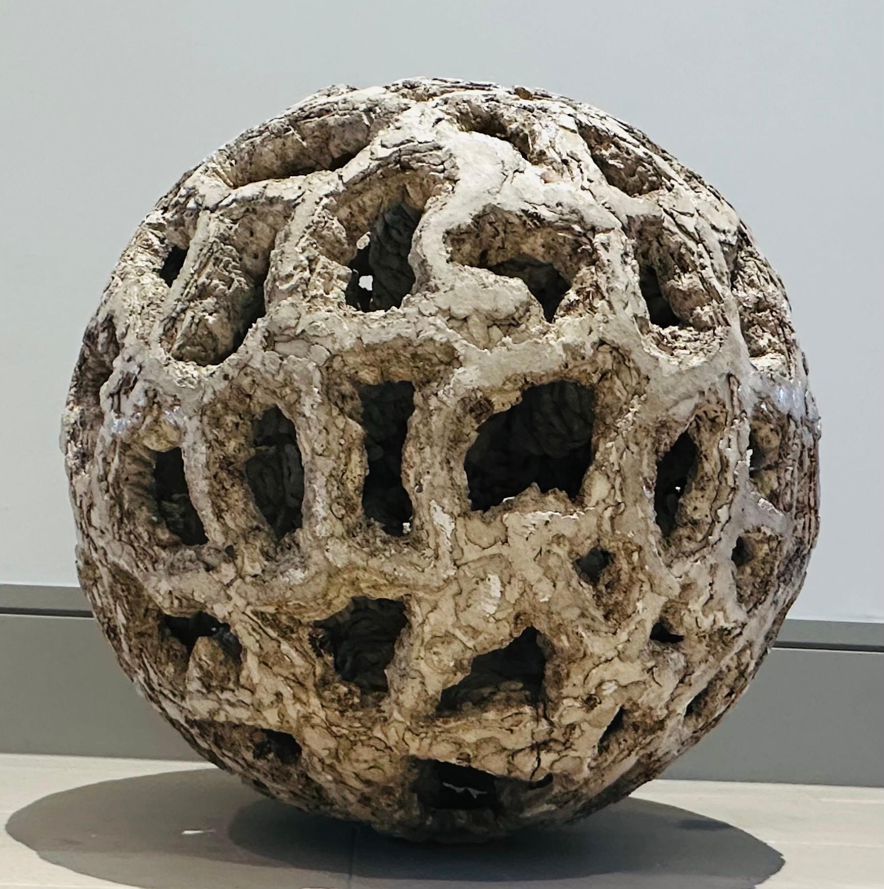 1960s French abstract terracotta space-age futuristic sculpture in the form of a volcanic rock.  An unusual volcanic, lunar rock or coral designed sculpture with a glazed and unglazed rough surface with amoeba shaped holes which allow you to peer