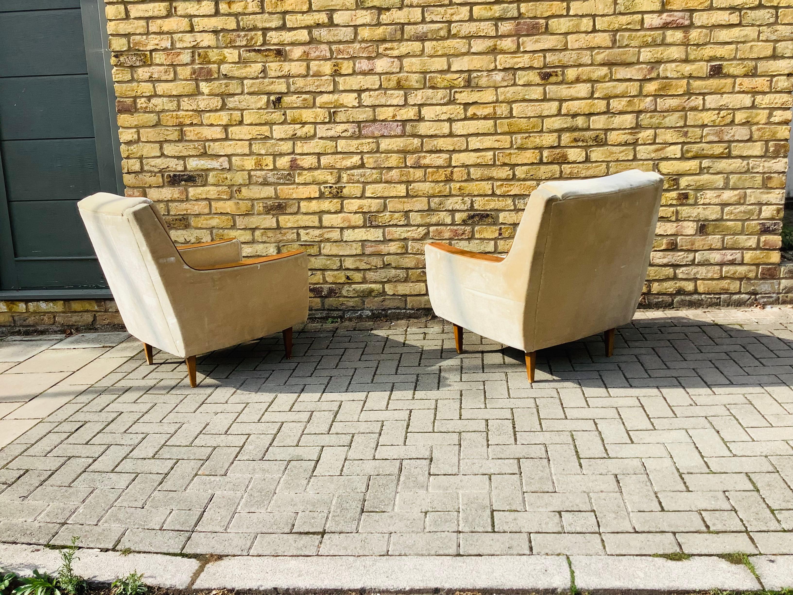 A pair of armchairs soft light velvet wooden detail arms 

French 1960’s.