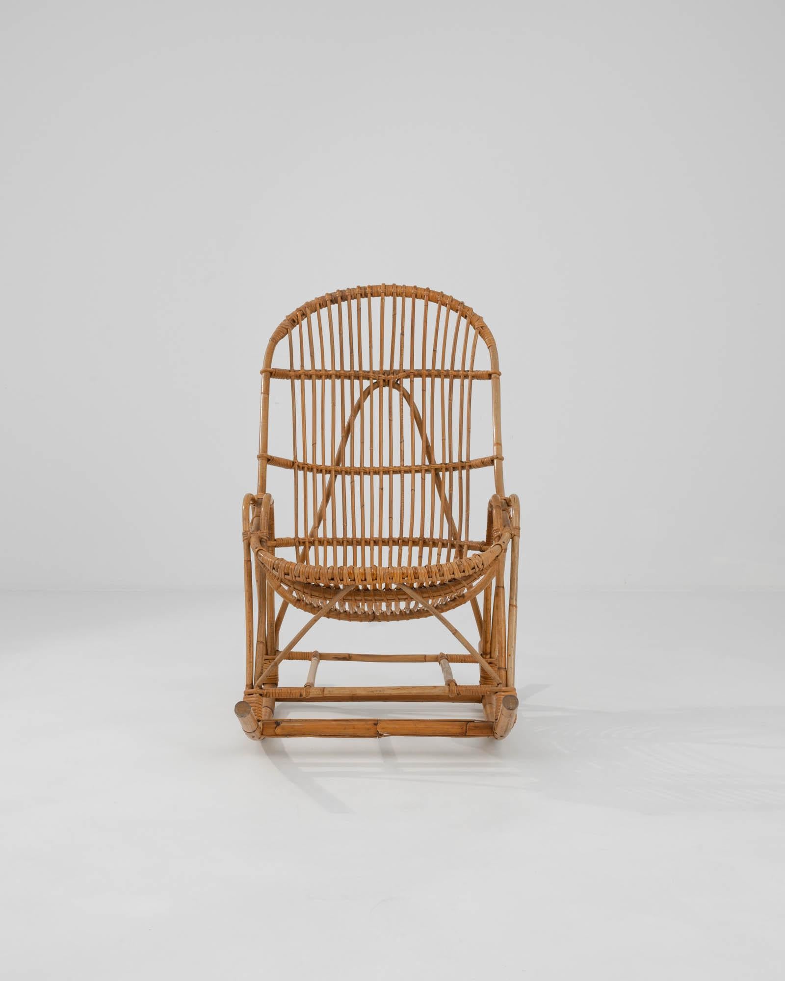Introduce el encanto de los años 60 con esta exquisita butaca mecedora francesa de bambú, una pieza que combina a la perfección forma y función. Fabricada íntegramente en bambú, esta silla presenta un diseño único de tejido abierto que proporciona