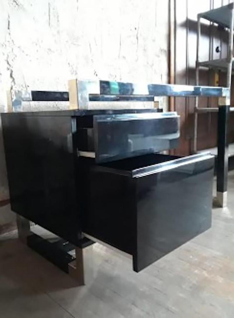 This beautiful 1960s French desk with lacquered black paint and a blue glass top. This desk features ample storage space creating a both functional and stylish design.