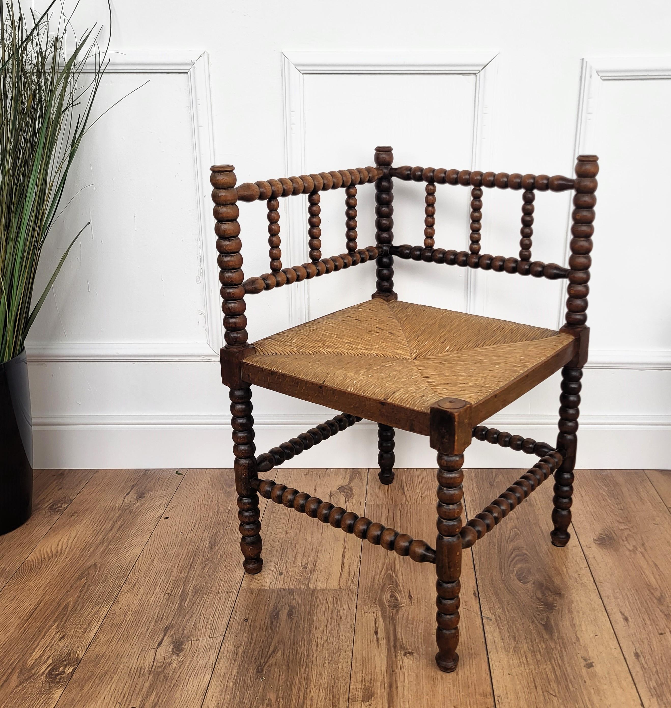 A charming dark wood stick and ball craftmanship corner chairs with original rush seat. We do have available as well the matching bench.