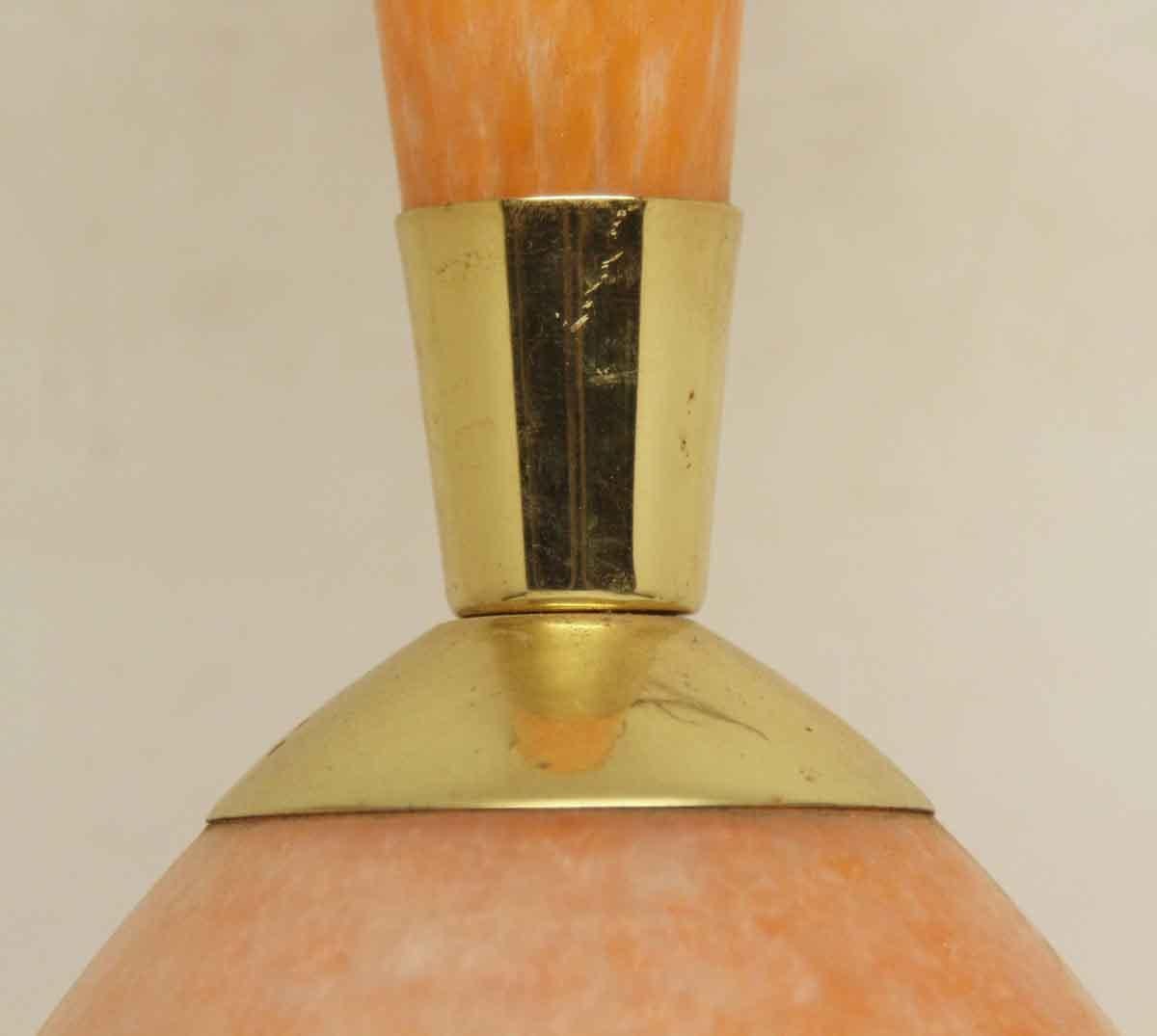 1960s Mid-Century Modern pendant light with an orange blown glass shade and neck with a brass center from France. This light has a small chip. Sold in as is condition. This can be seen at our 400 Gilligan St location in Scranton, PA.
