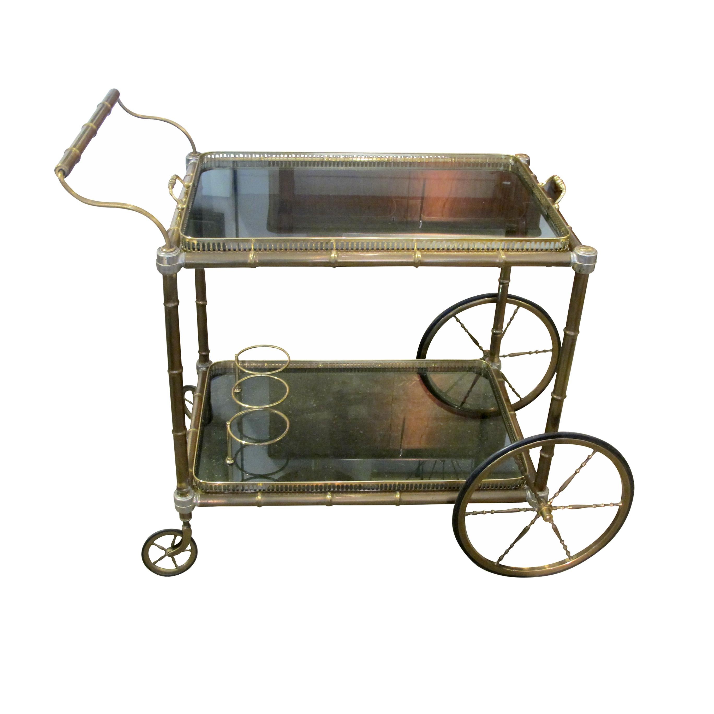 A 1960s well-made brass serving bar cart/trolley with an interesting bamboo effect on the wheels. The trolley is in great condition with fully functioning wheels which all work well. The two smaller swivelling wheels at the back allow it to be