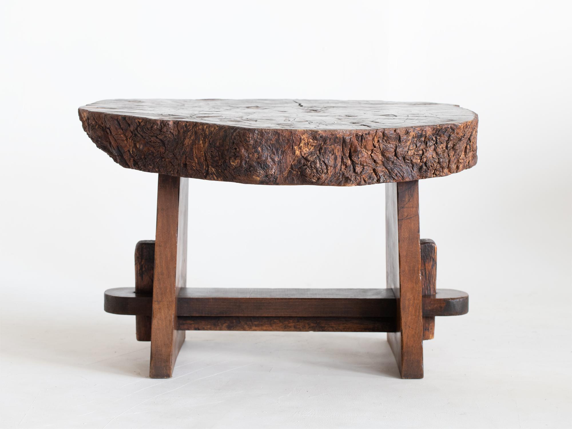 A brutalist live-edge coffee table with single slab of oak top raised on a beech trestle-form base. French, c. 1960s.

A heavy and solid piece with great character.

53 x 82 x 73 cm

20.9 x 32.3 x 28.7 