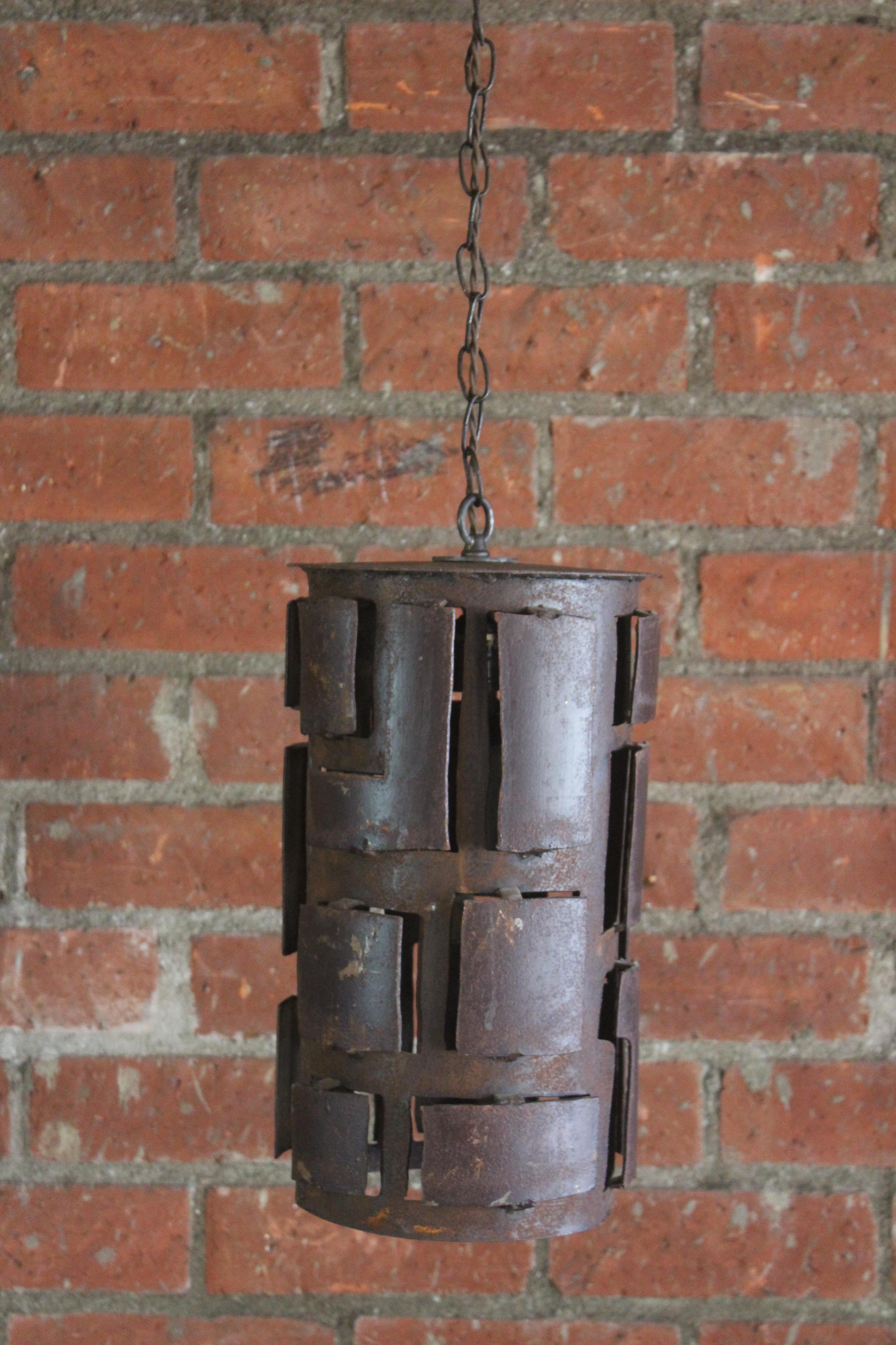 Four vintage iron brutalist pendant light fixtures. Handmade in France, 1960s. Unique and one of kind. Recently rewired for U.S standards. Each pendant is 15.5 inches high and 10 inches diameter. 63