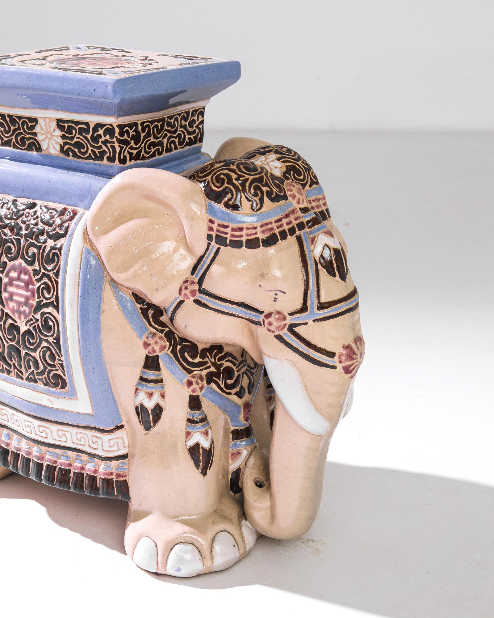 A ceramic decoration from 1960s France in the shape of an elephant. A saddle seat and blanket are glazed with creamy white and powder blue; the assortment of delicate patterns — reflecting Chinese and Arabic influences — suggest the romance of the