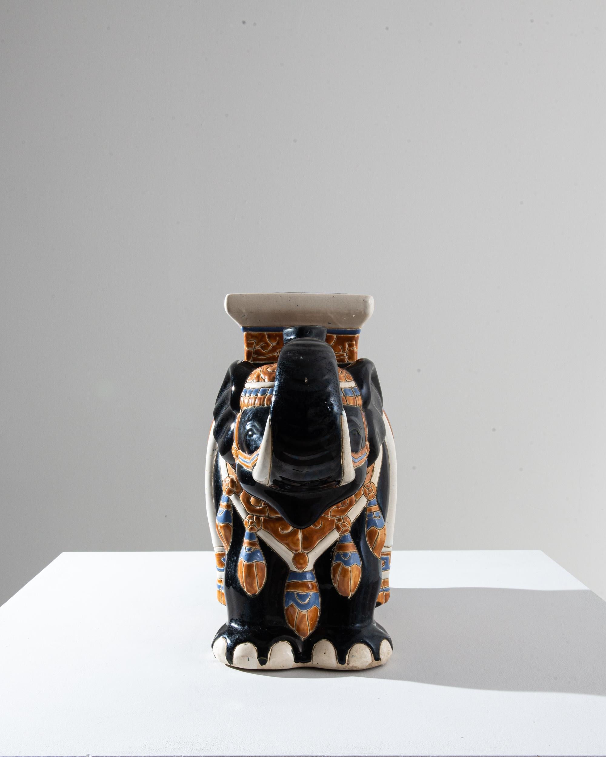 A ceramic decoration from 1960s France in the shape of an elephant. Glazed in a deep blue laced with powder blue and yellow ochre; the saddle, seat and blanket are delicately patterned — reflecting Chinese and Arabic influences — suggesting the