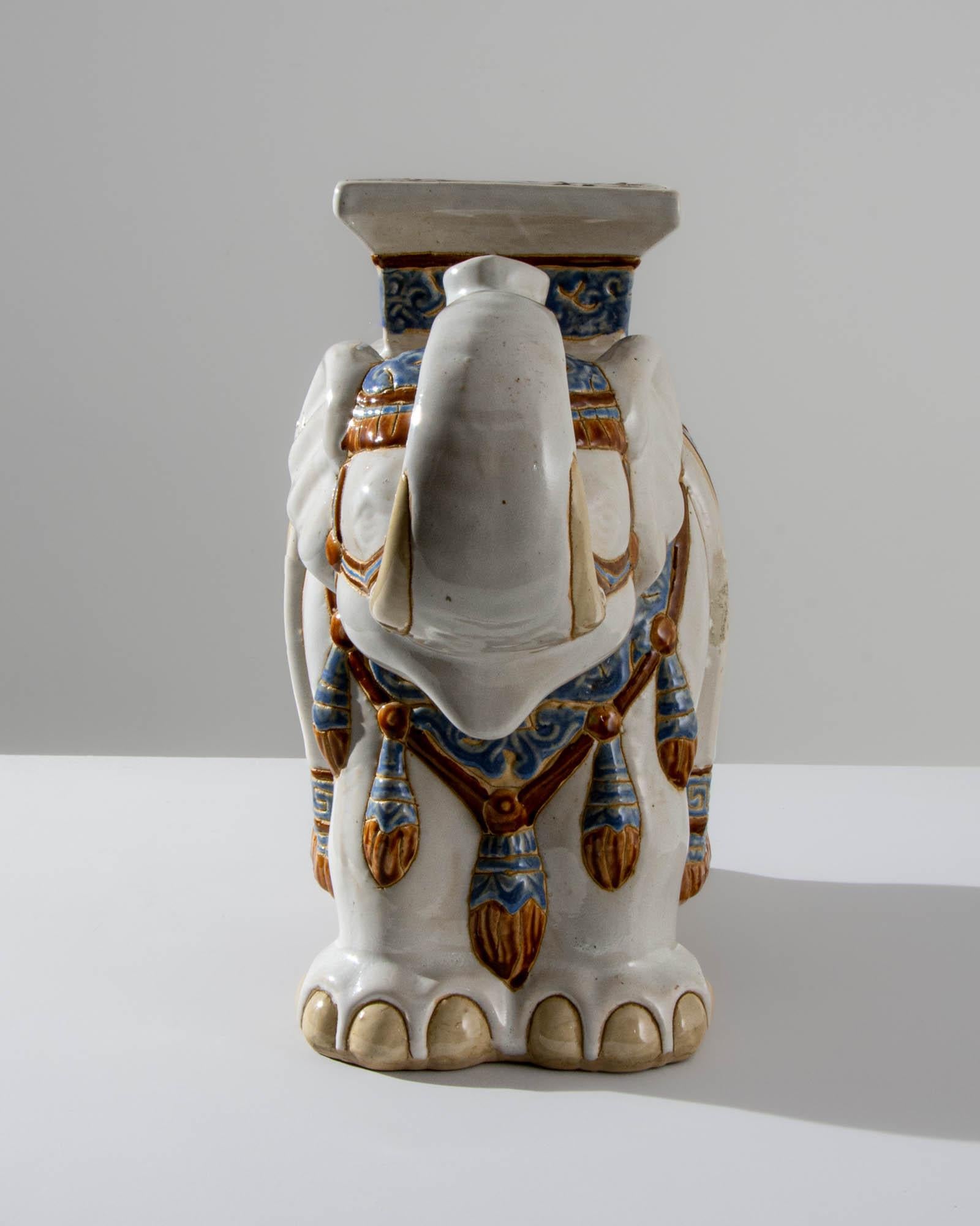 A ceramic decoration from 1960s France in the shape of an elephant. Painted with a white glaze laced with powder blue and yellow ochre; the saddle, seat and blanket are delicately patterned — reflecting Chinese and Arabic influences — suggesting the