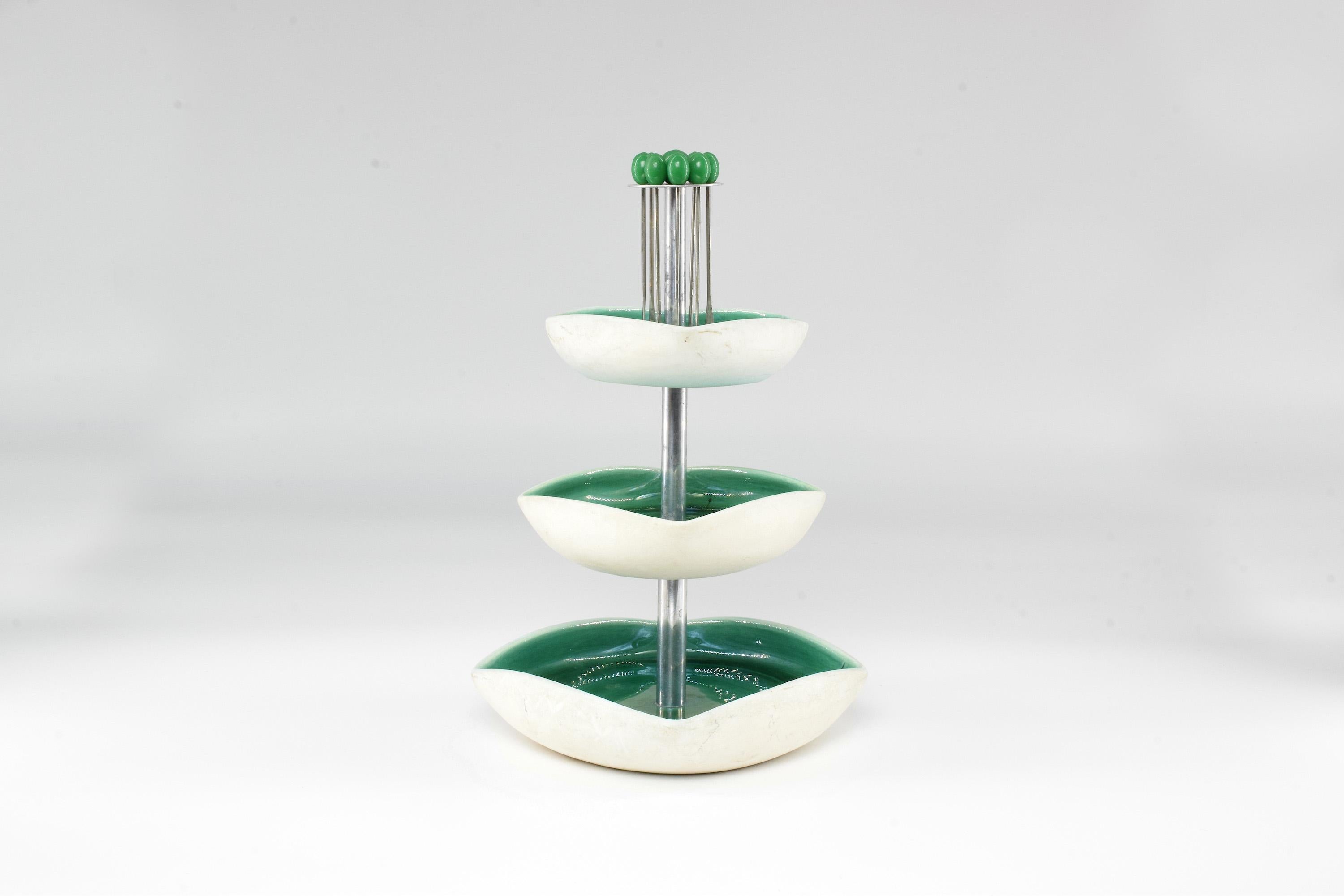 A delightful tiered three platter serving tray crafted with curved ceramic in green and white and the original food picks hanging at the top. 
A lovely piece when hosting cocktails. 
France. 1960's.


 