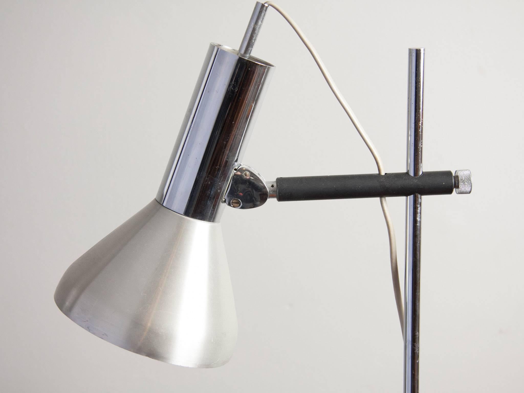1960s French polished and brushed chrome adjustable desk lamp with a heavy cast iron contrasting base and supporting arm. The angle and height of the lamphead is adjustable to control your exact lighting requirements. The cone of the lamphead is