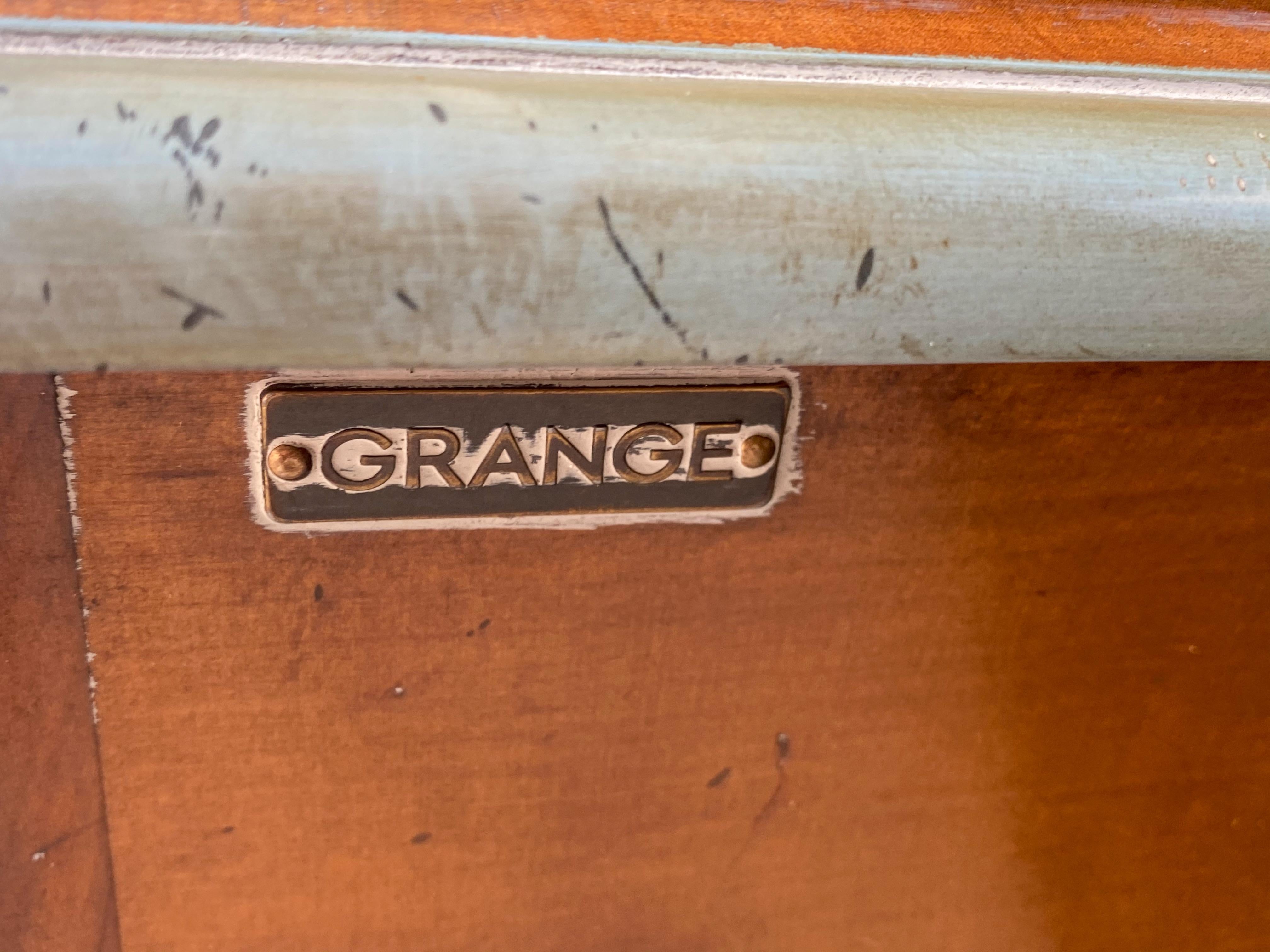 This is a 1960s French pine serving piece by Grange Furniture. The construction is wide planked pine. It is in very good condition with intentional distressing. It has turquoise painted trim and interior. The period style bronze hardware is