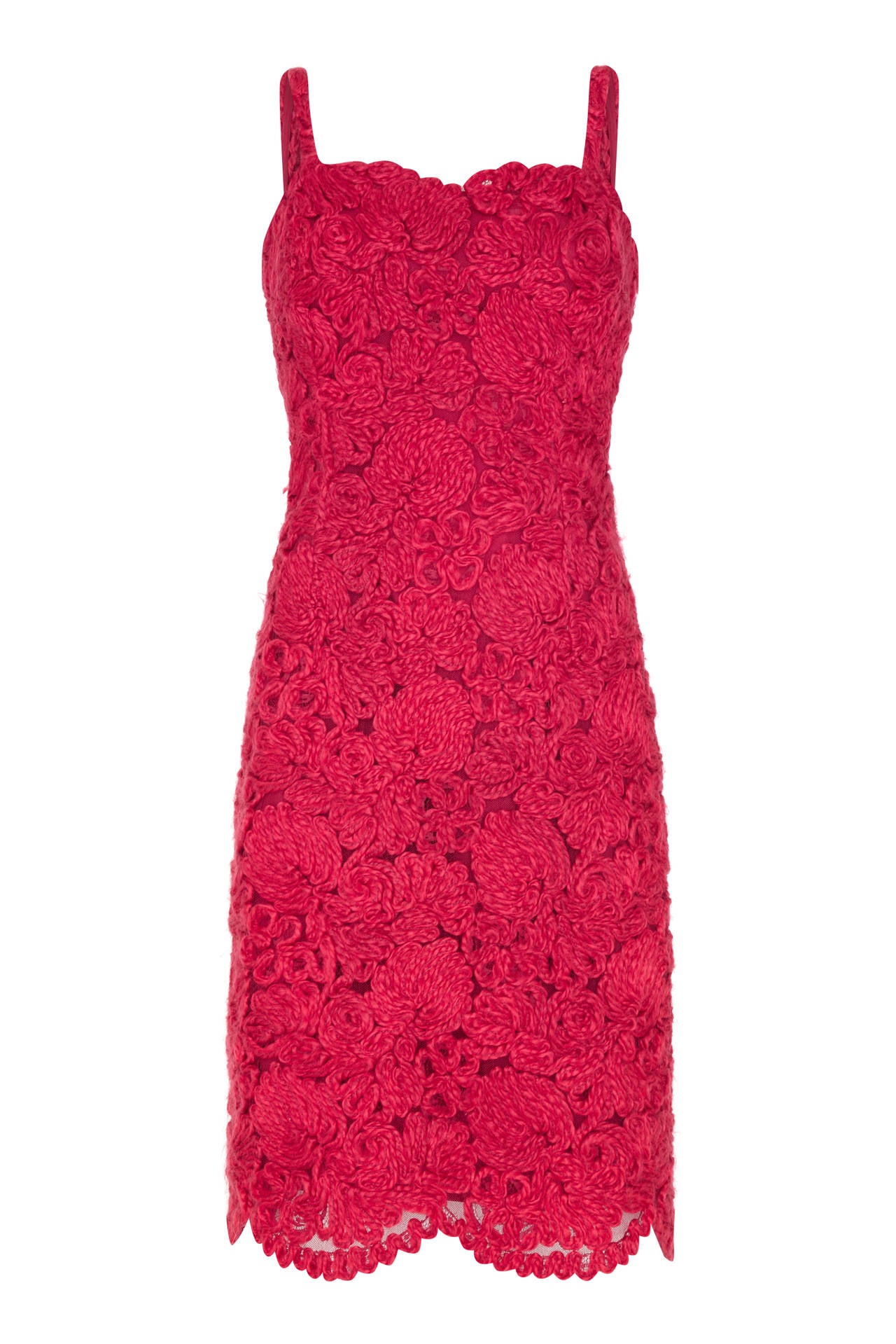 This magnificent 1960s French couture dress suit in scarlet appliqué is of exceptional quality and a rare and unusual find. Both separates are comprised of a soft woollen appliqué style embroidery arranged in a swirling floral design over a net