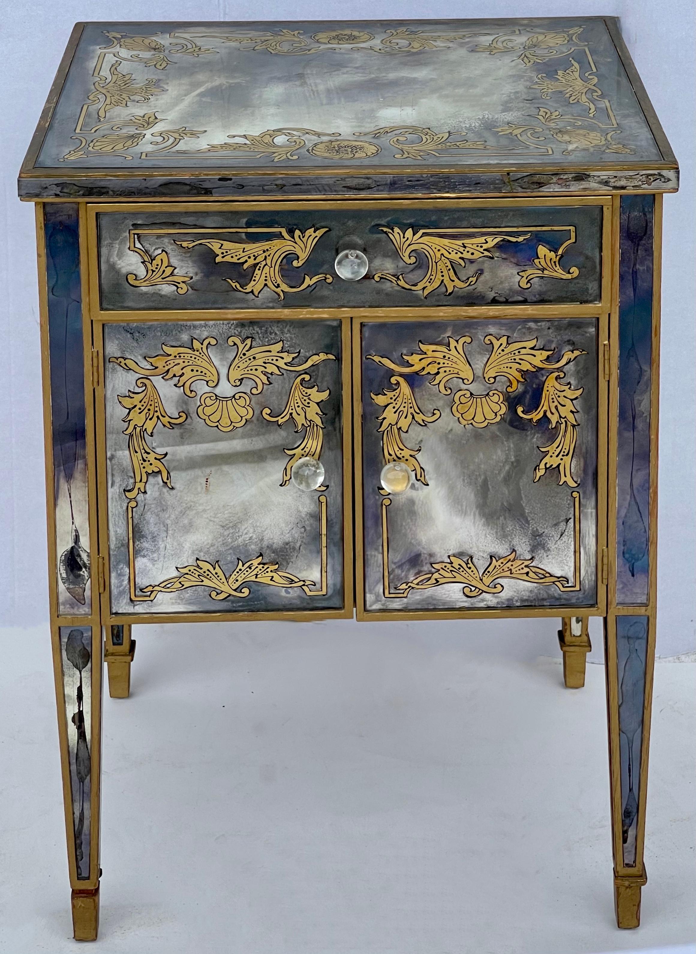 This is a pair of 960s French englomise mirrored chest or side tables attributed to Maison Jansen. They are not marked. The reverse painting is in gilt. They do show some age appropriate wear.