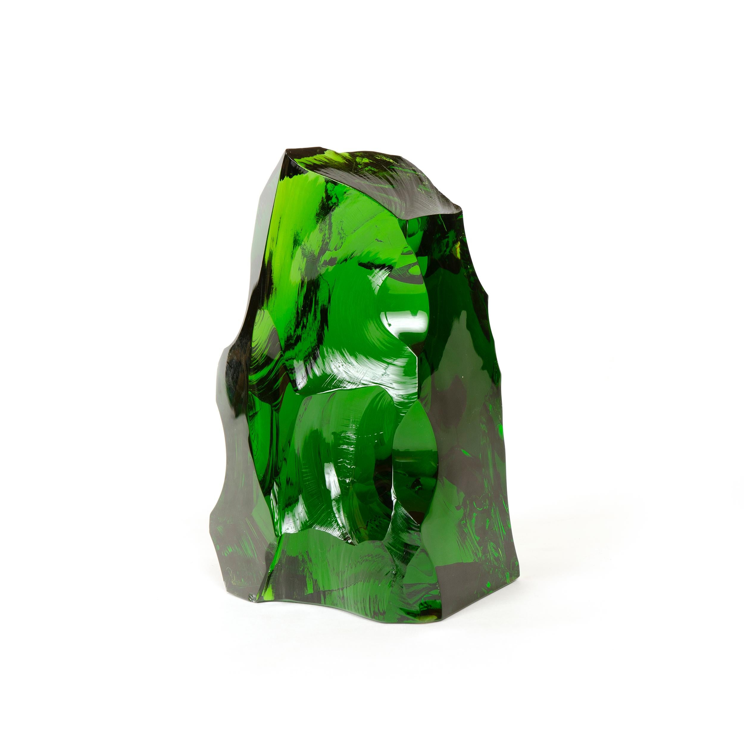 Baccarat sculptural mass of pure glass in a deep emerald green giving the appearance of being rough hewn or naturally formed resembling a glacier. Signed with an etched Baccarat signature in script as well as the company’s circular mercury ink stamp.