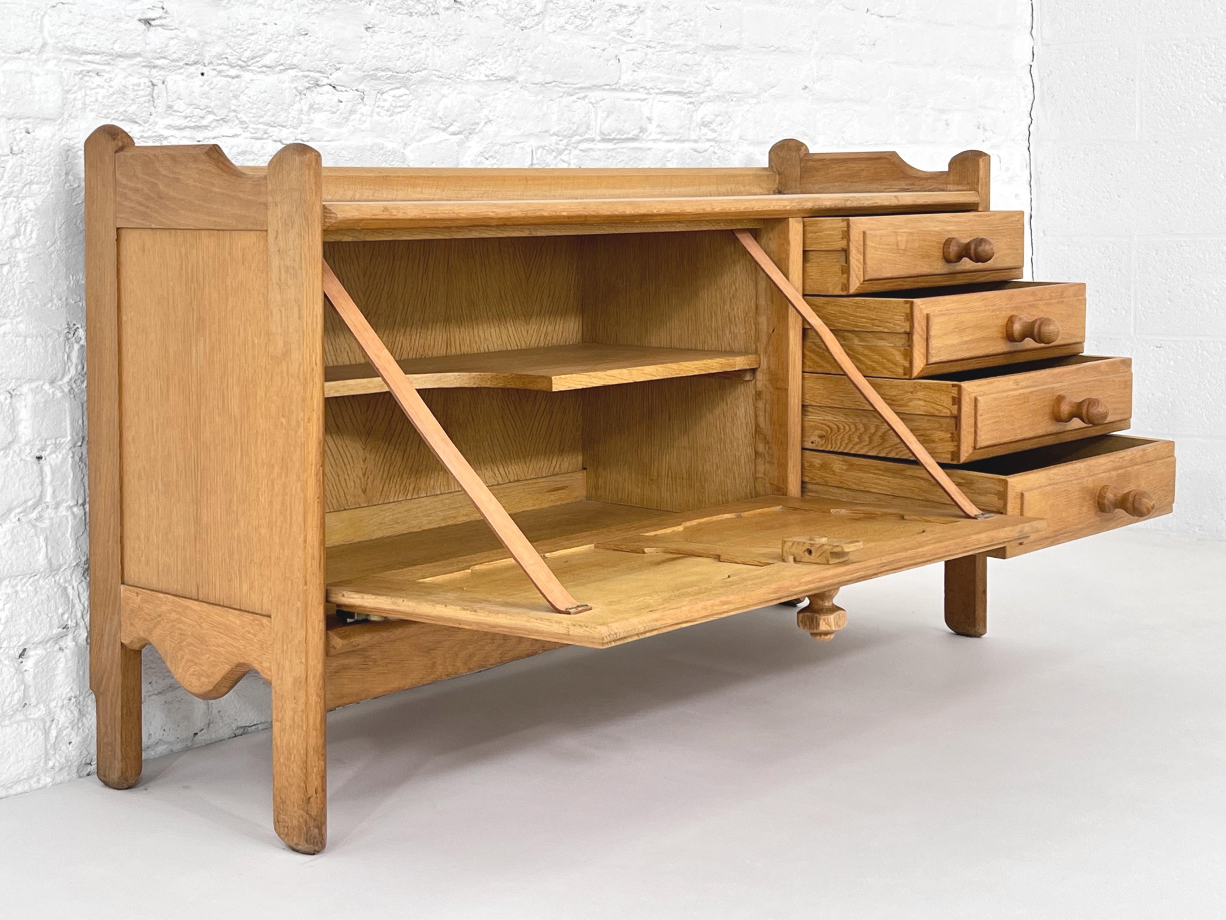 1960s French Guillerme & Chambron Design Oak Wooden Bar Cabinet composed of 4 drawers one side and a bar storage space tilting door opening system with leather straps and brass finishes. Fine craftmanship, graphic panel door.