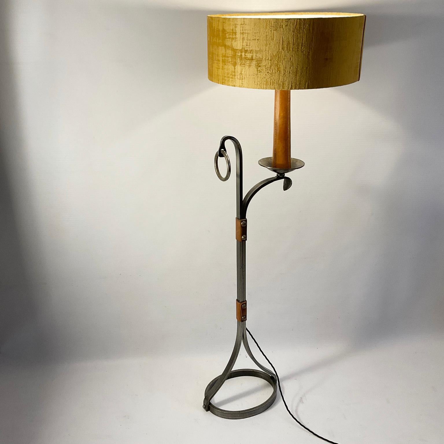 Mid-Century Brutalist Wrought Iron Floor Lamp by Jean-Pierre Ryckaert for Maison Le Dauphin,
A hammered wrought iron floor lamp decorated with thick bolted leather and an oval base, having a curved arm with a candle covered in saddle stitched