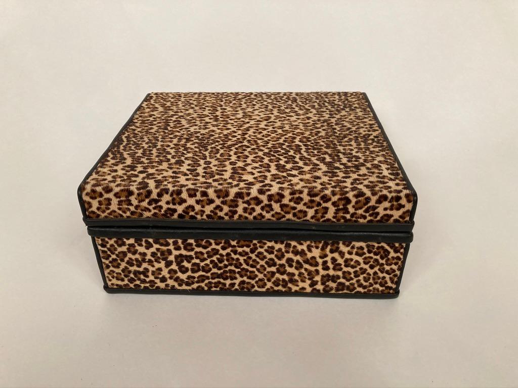 A midcentury French box covered in leopard skin with black leather trim and an interior of black dyed lizard skin. With beautiful brass hinges, a bespoke item of admirable craftsmanship. Very much of the 1960s era, brings to mind Bob Dylan's song