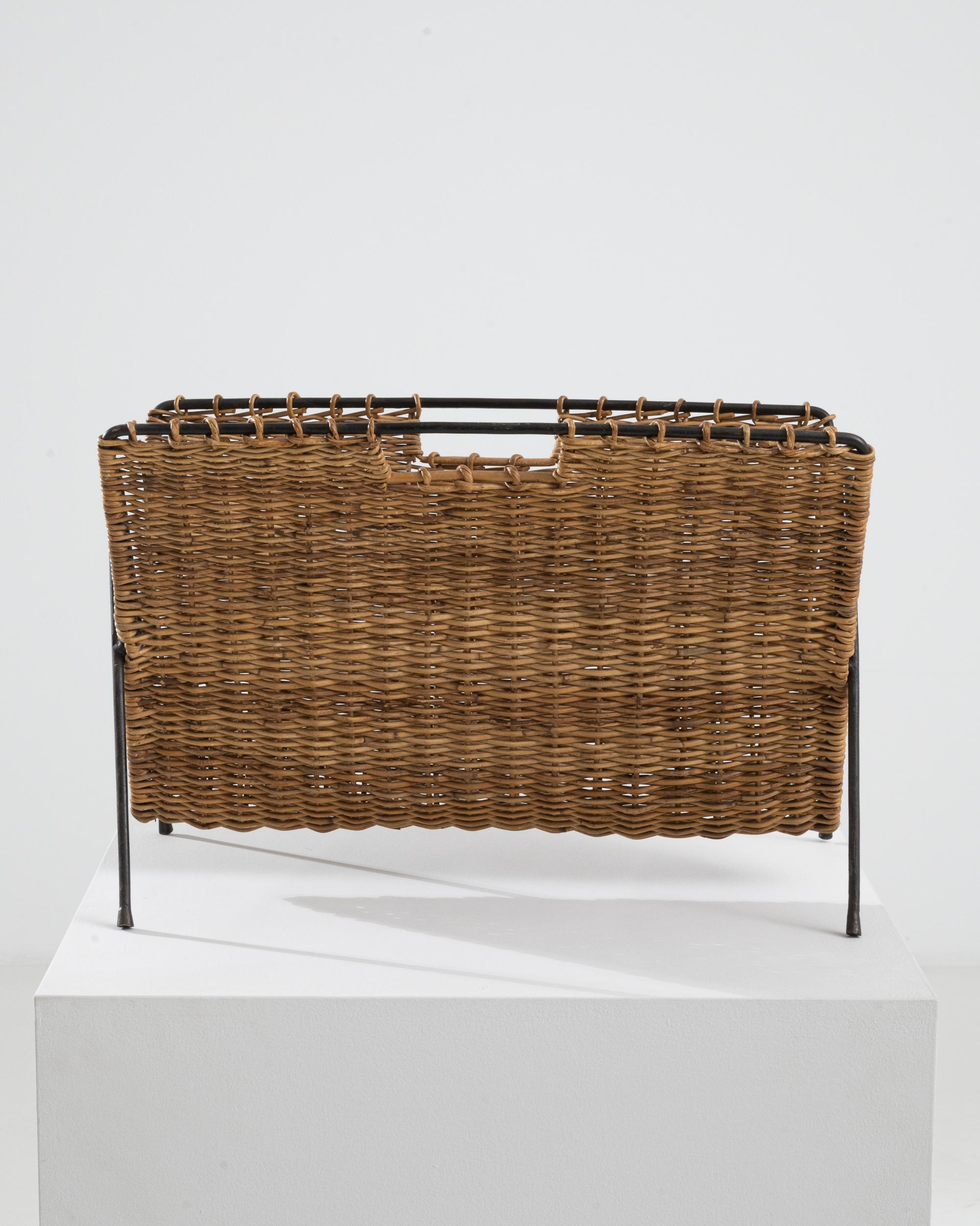 This vintage platter was made in France, circa 1960. A ‘V’ shaped caddy with a complimentary ‘A’ base, the woven Material finds its unlikely mate in the metal structure. Radiating 1960s charm, the metal feet give an anamorphic quality. Cane is woven