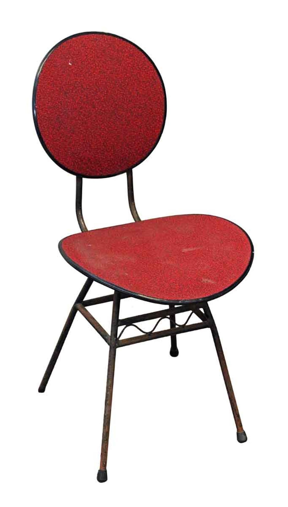 1960s Mid-Century Modern black metal frame chair with a red and black textured plastic seat and back. One available. This can be seen at our 400 Gilligan St location in Scranton, PA.