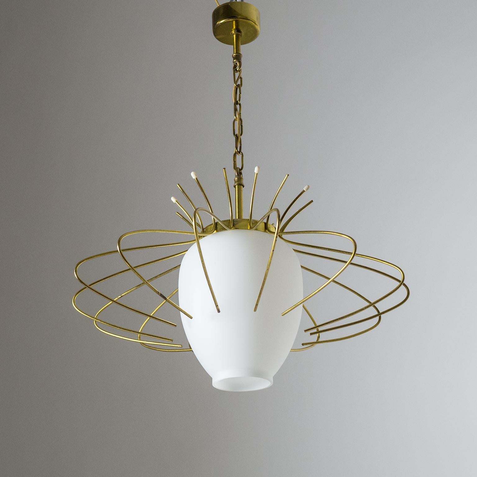 Lovely French modern pendant from the 1960s. The cased glass diffuser has a satin finish and is surrounded by a delicate brass wire structure. Very good original condition with a nice patina on the brass. One brass and ceramic E27 socket with new