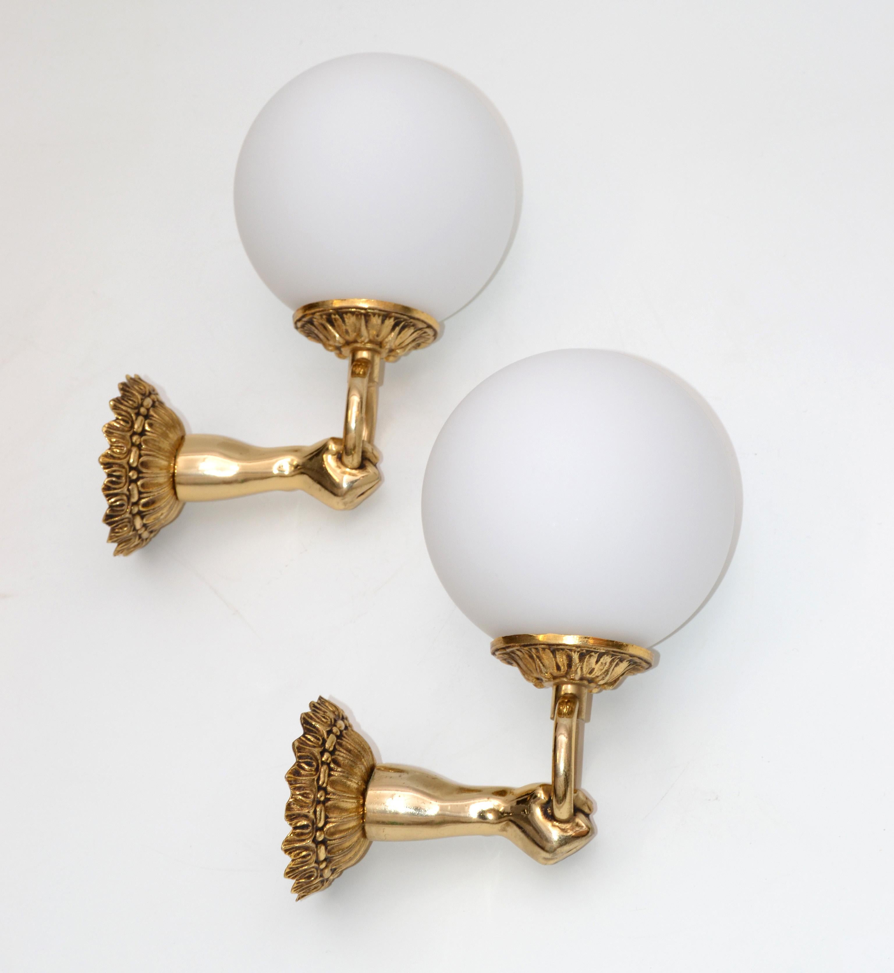 Pair of French neoclassical wall sconces figuring a hand holding a globe.
3 pair available.
Each takes one light bulb with max. 60 watts.
US wired and in working condition.
Back plate measures 3.25 inches in diameter.
Please have a look on our