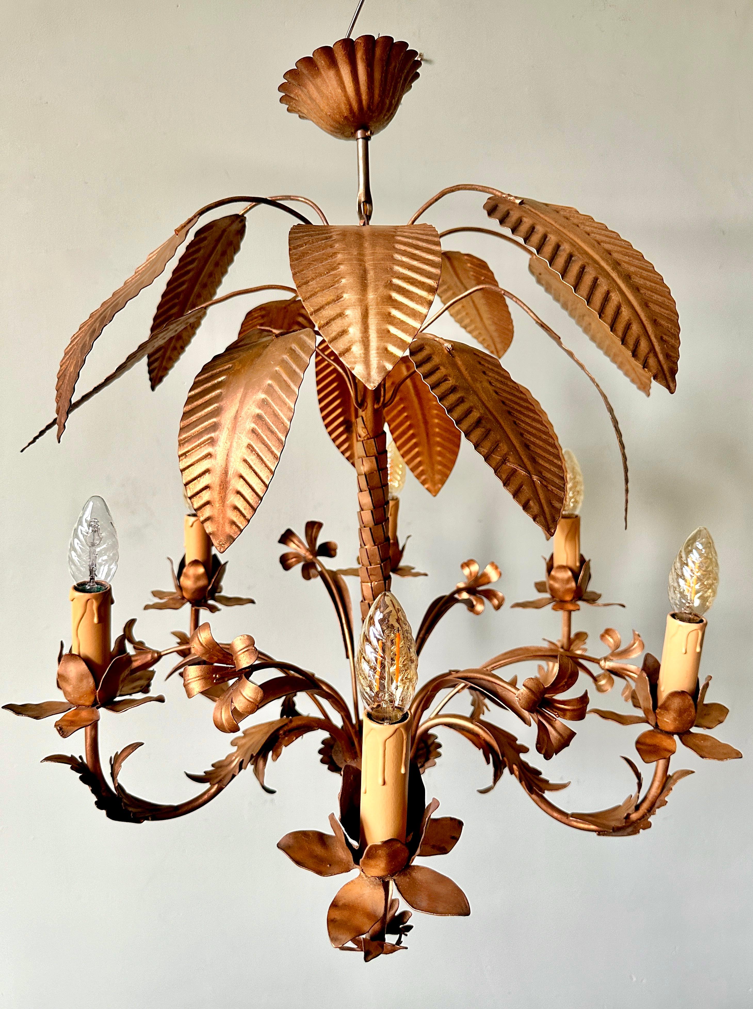 1960s French palm tole chandelier.

Beautiful hand-painted, six-arm ceiling light in the style of Parisian design house Maison Jansen. In excellent condition with light and attractive wear. A surface mark on one leaf (see photos). The chandelier has