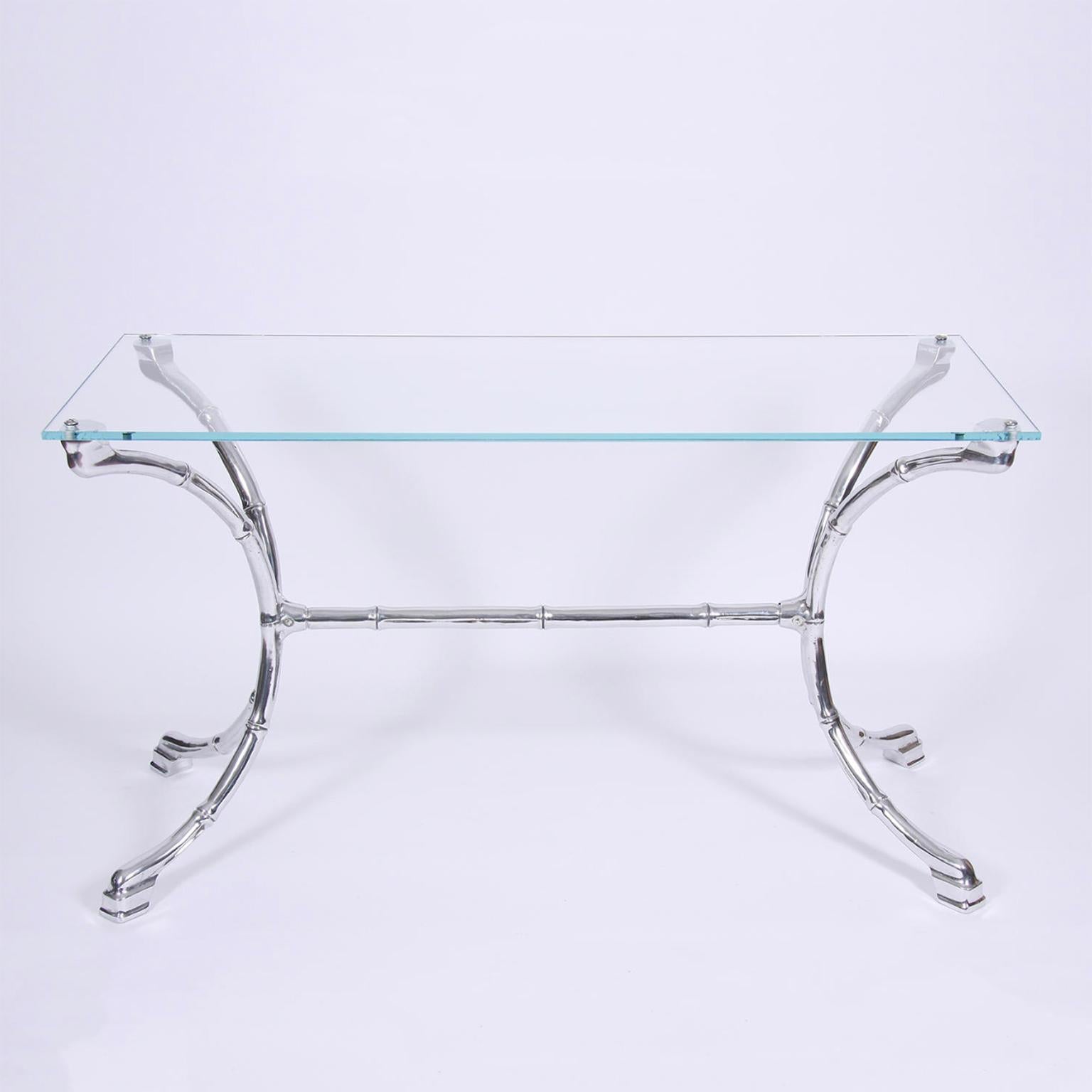 French, circa 1960

A rather striking faux bamboo console table made from polished cast aluminium. With a clear toughened glass top. Perfect as a console table or a small desk.