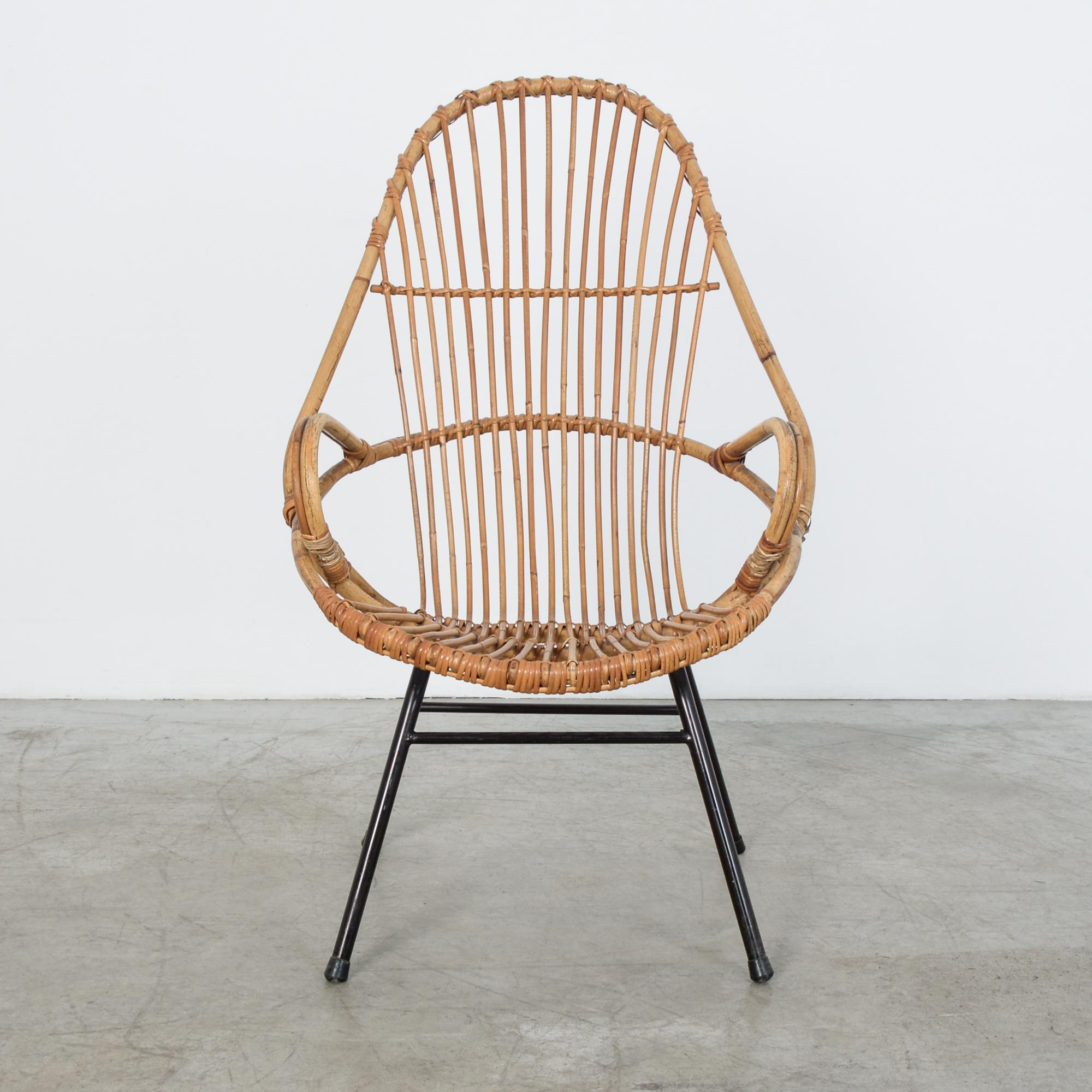 Bamboo and rattan chair from 1960s, France. On a simple metal frame a stylish curved seat reclines comfortably. This informal bamboo chair gives us a wanted moment of relaxation.
   