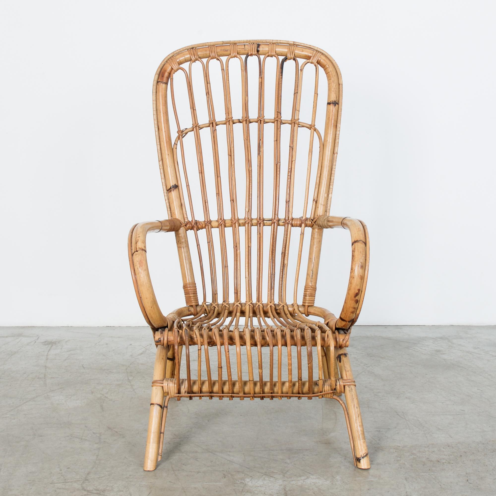 The chair from your childhood. An idyllic past, warm and comfortably inviting a fresh future. Bamboo and rattan chair from 1960s, France. On a frame a stylish curved seat reclines comfortably. This unpretentious bamboo chair gives us a wanted moment