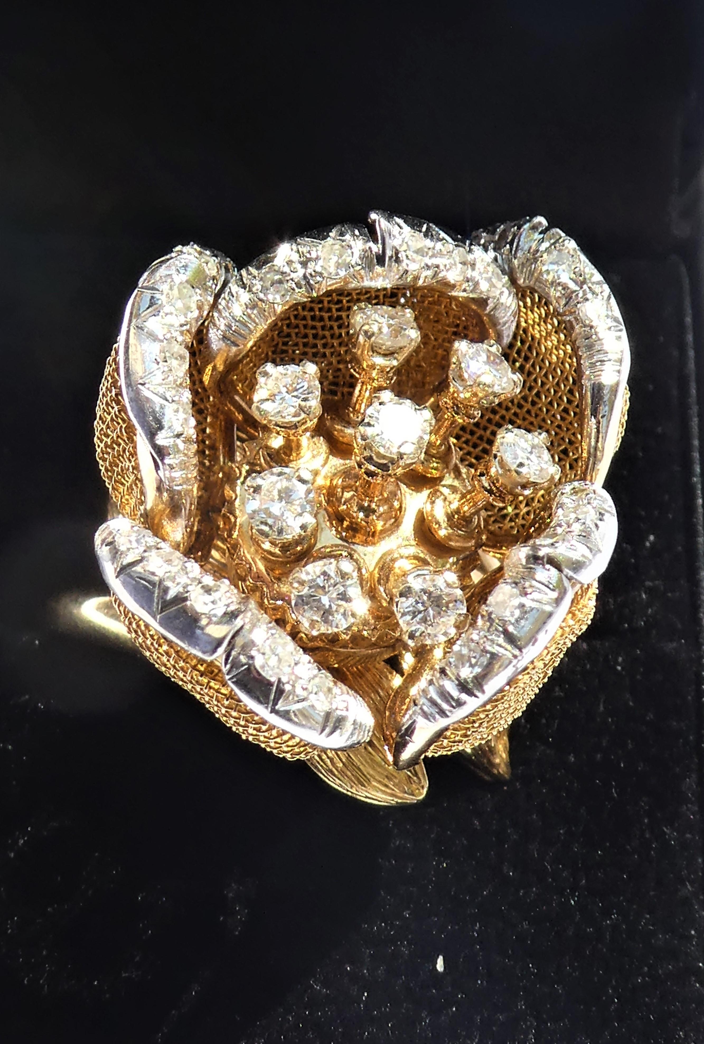 Representing a rose, this ring is articulated and can present the flower open or closed in bud. The five movable petals are made of woven yellow gold thread and the edge of the petal is set with a line of diamonds in white gold. The eight flower