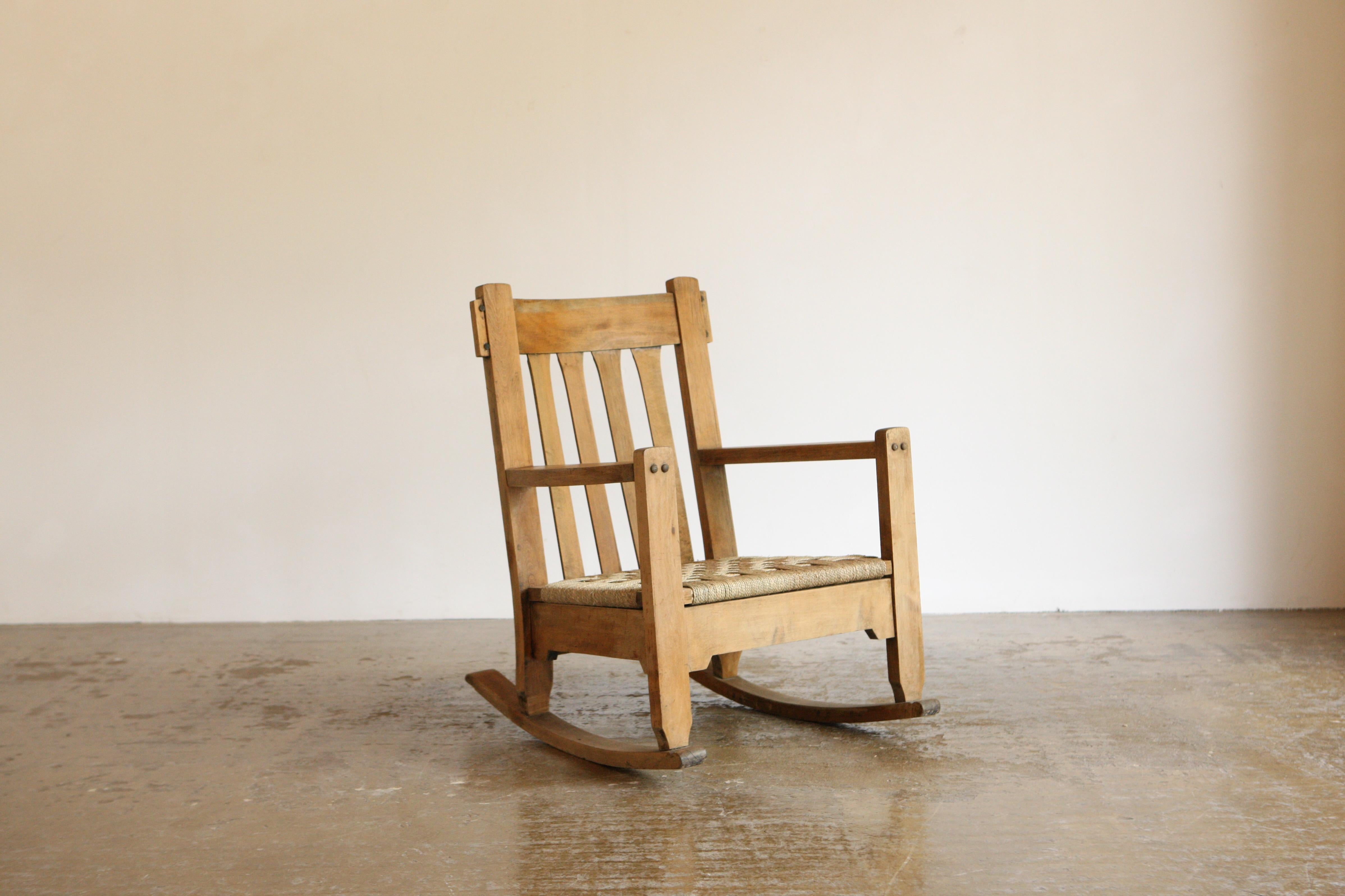 A deeply pleasing rocking chair with a large footprint and some lovely proportions. The base has a woven papercord seat and the overall construction is of such lovely  craftsmanship. 