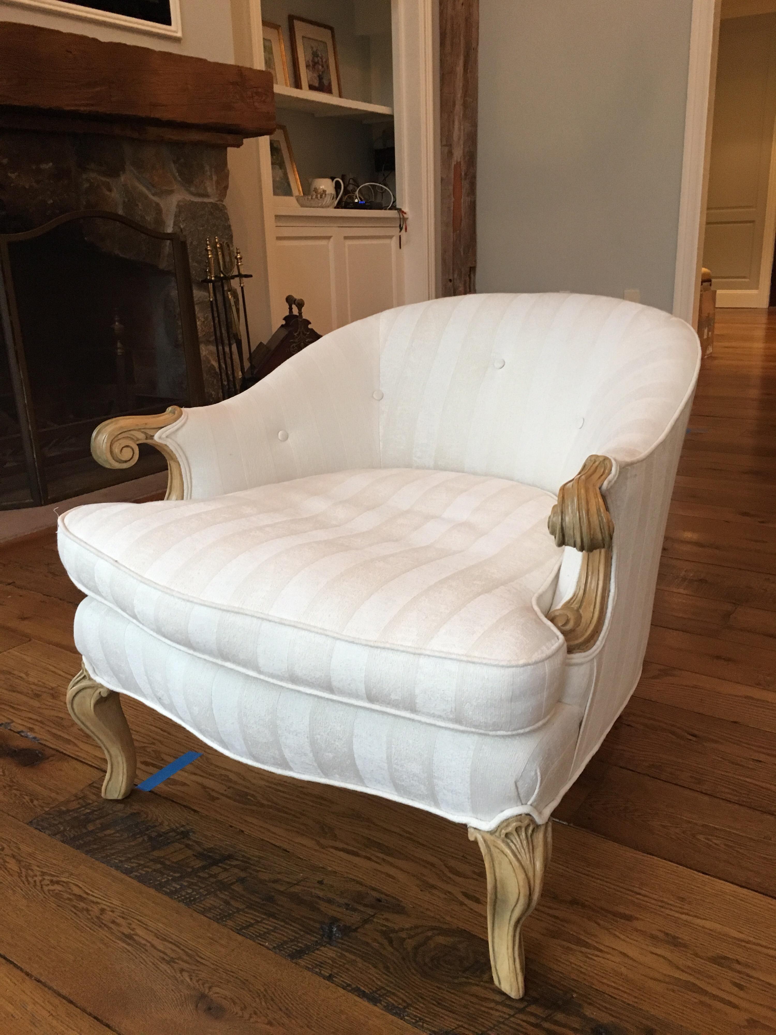 1960s French Rococo style low bergere chair. One available in excellent condition. Original gilded finish taken back to a pale blond finish. These low chairs are quite substantial and in very good condition. The upholstery could use an update.